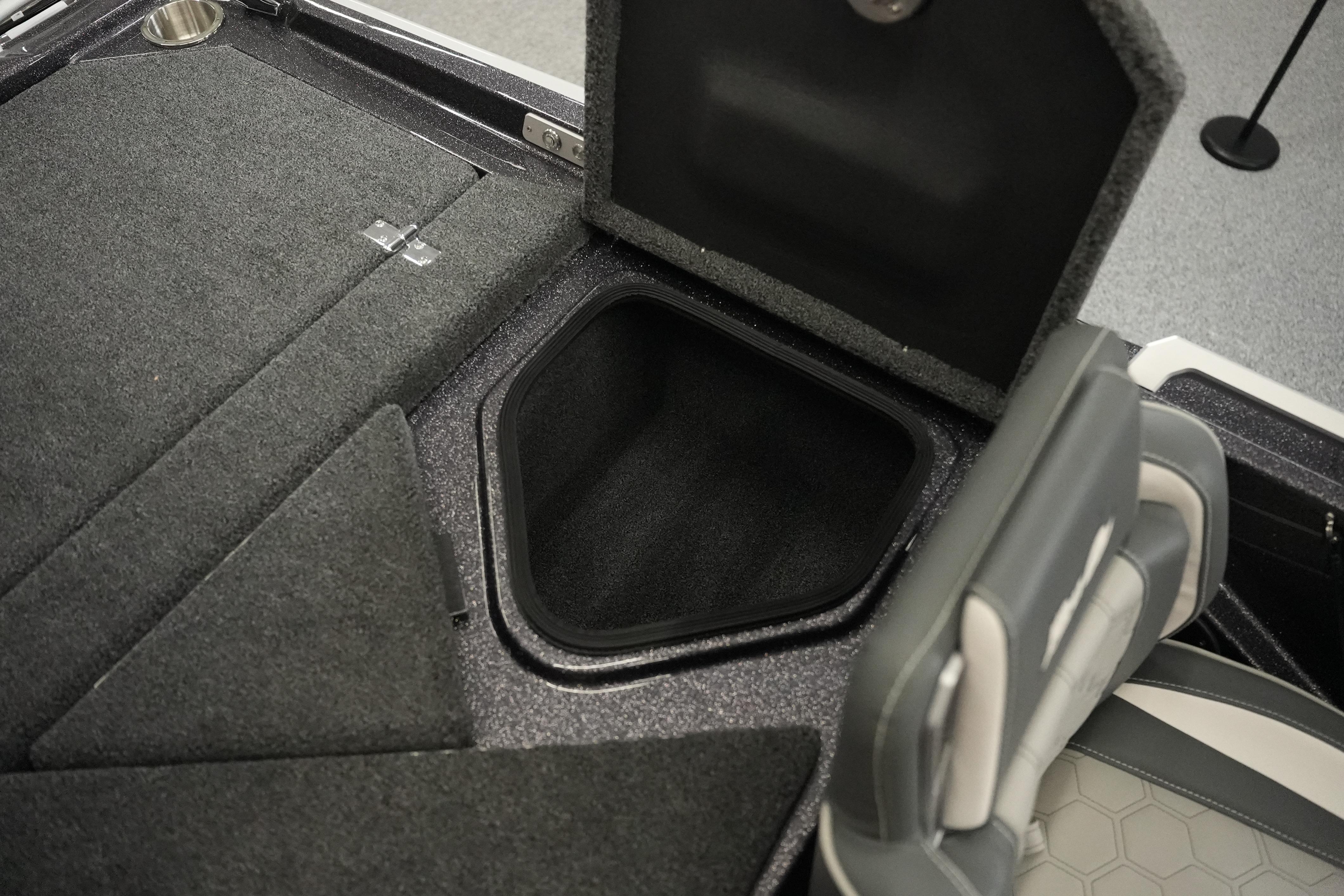 2026 Bass Cat Puma STS boat interior storage compartment with open lid and seating.
