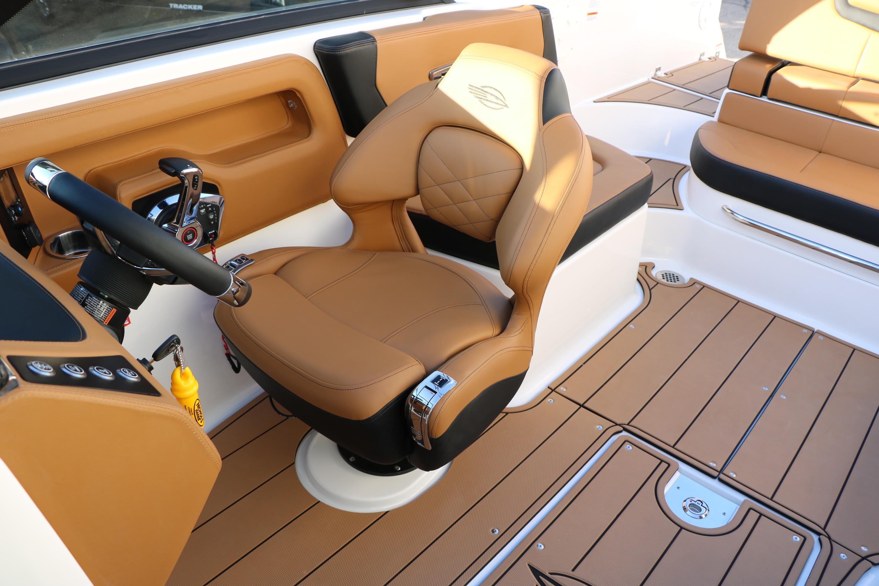 2026 Chaparral 247 SSX boat interior with tan leather seating and modern controls.