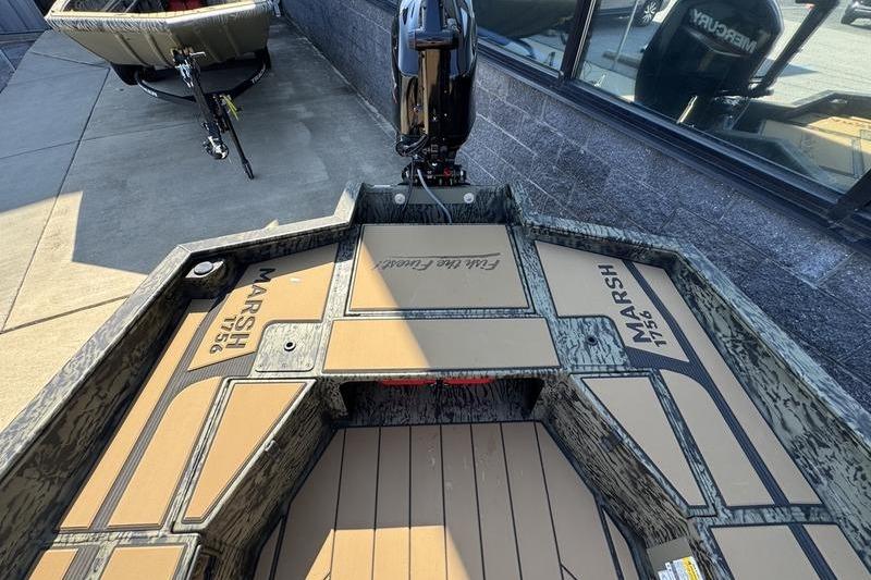2026 Tracker Grizzly 1756 T Marsh boat interior with camo design and motor.