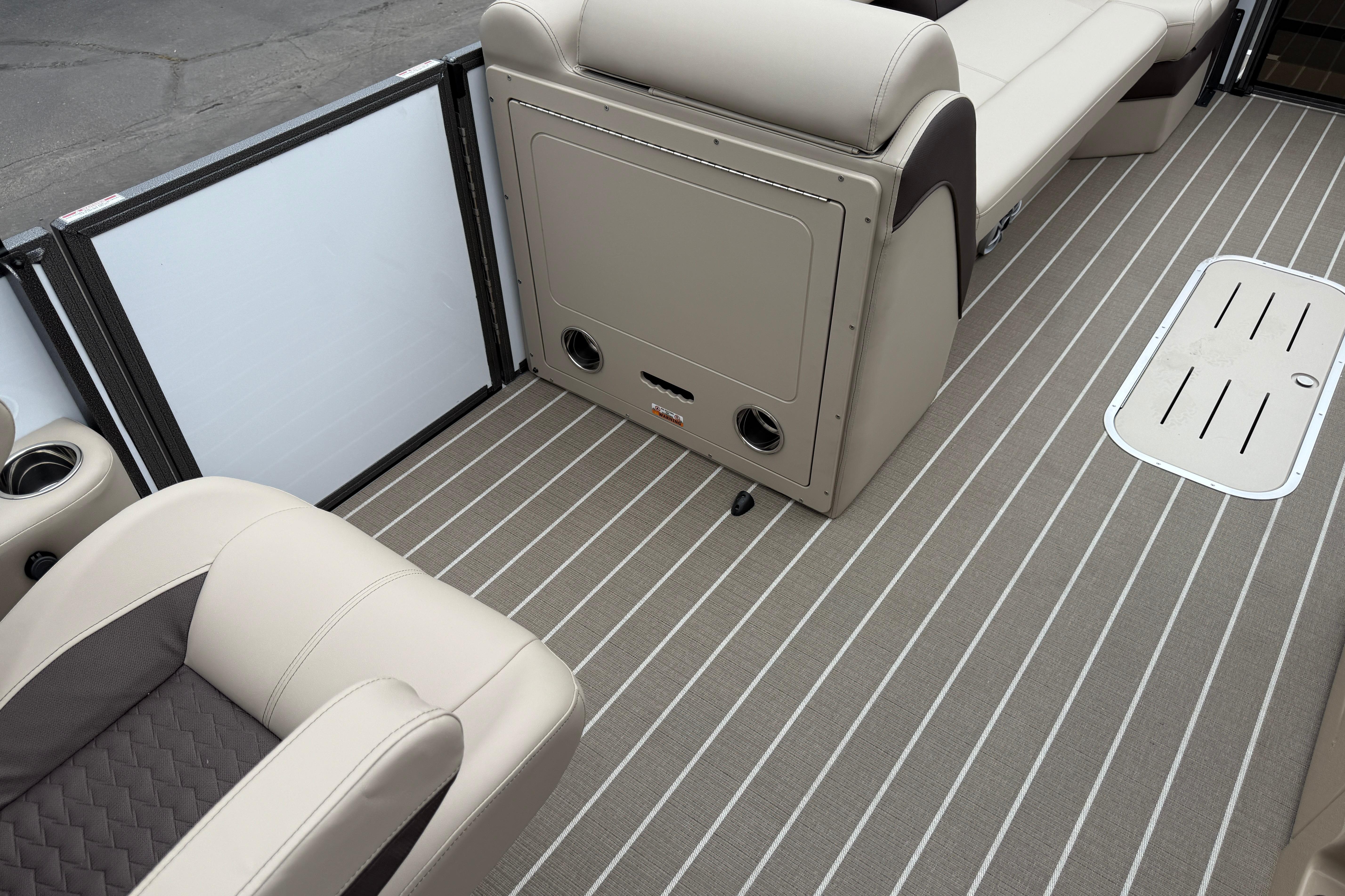 2026 Bentley Pontoons Elite 253 Admiral interior with beige seating and striped flooring.