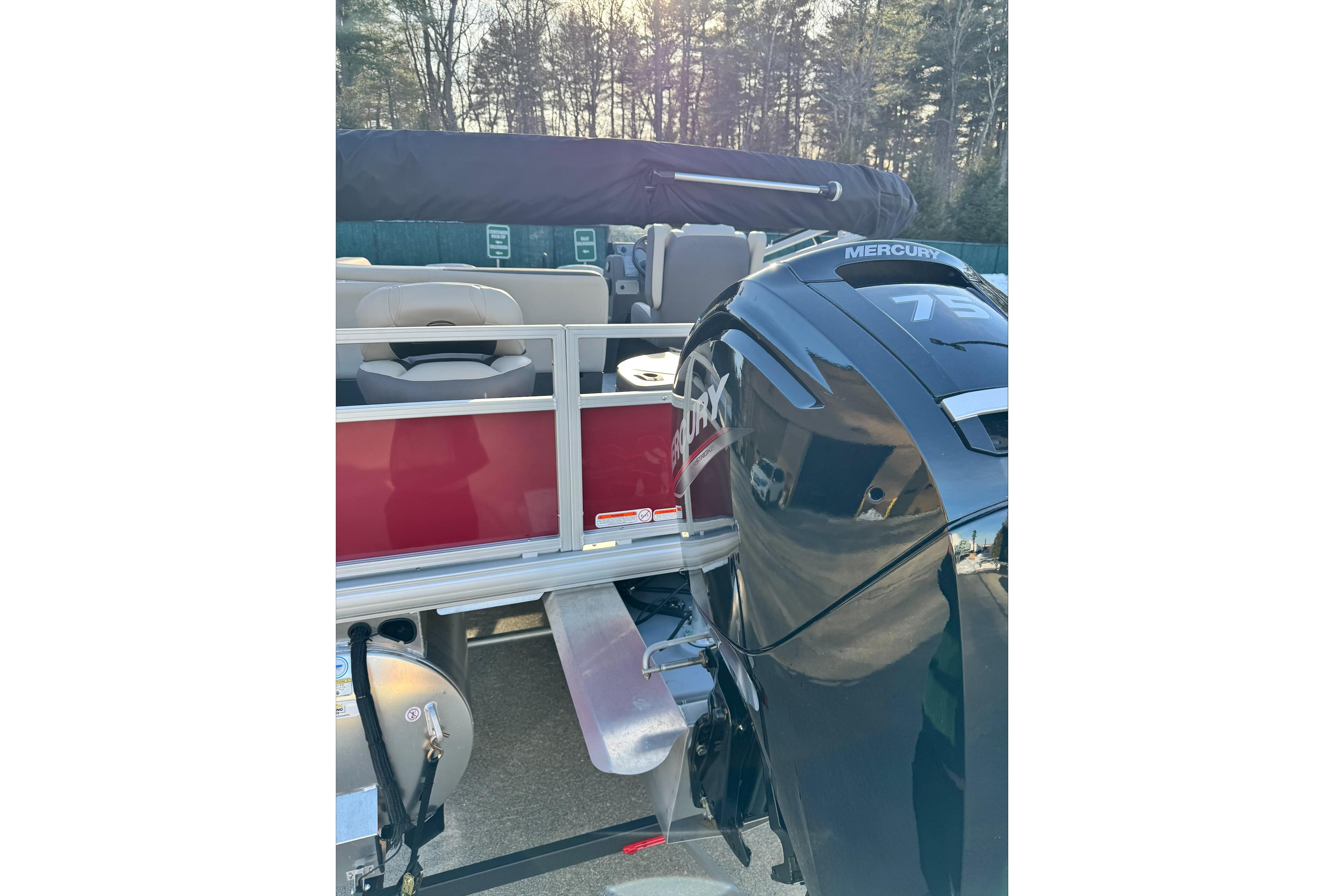 2026 Sun Tracker Bass Buggy 18 DLX with Mercury engine, rear view.