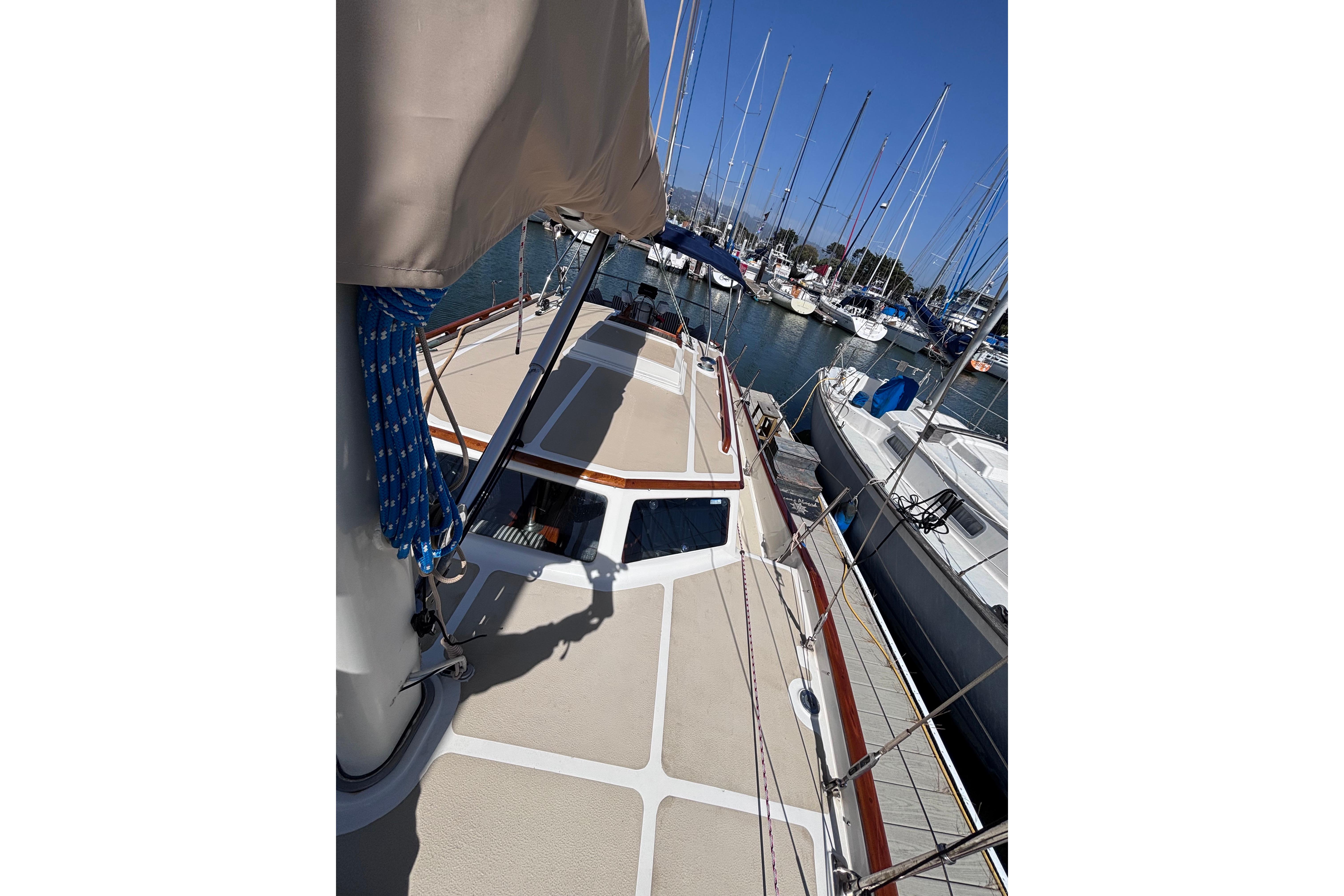 1978 Swift 33 sailboat docked in a marina, surrounded by other boats.