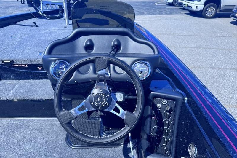 Steering console of a 2026 Phoenix 819 ZXL boat, featuring gauges and controls.