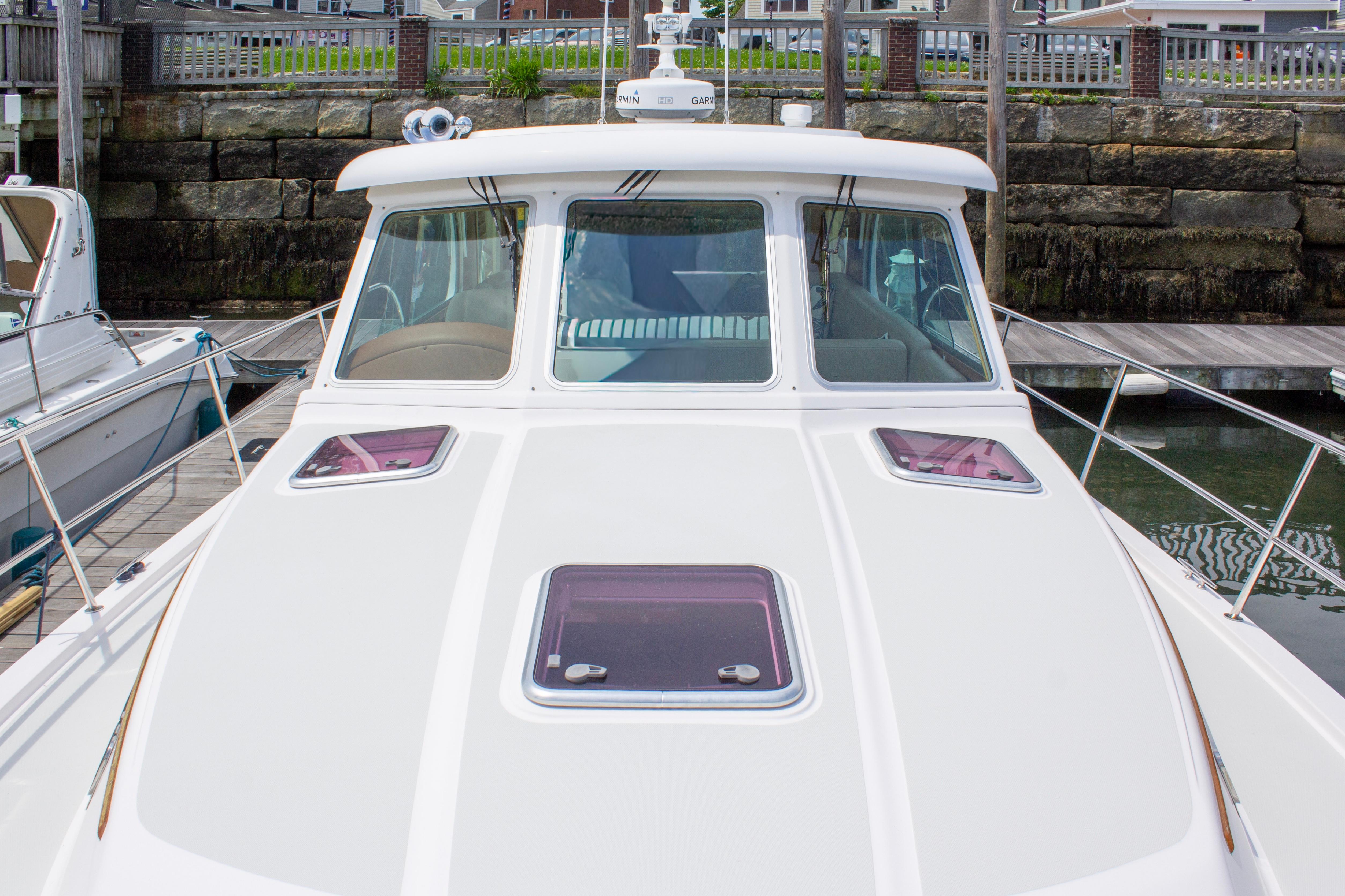 2013 Sabre 38 Salon Express yacht docked, showcasing sleek design and spacious deck.