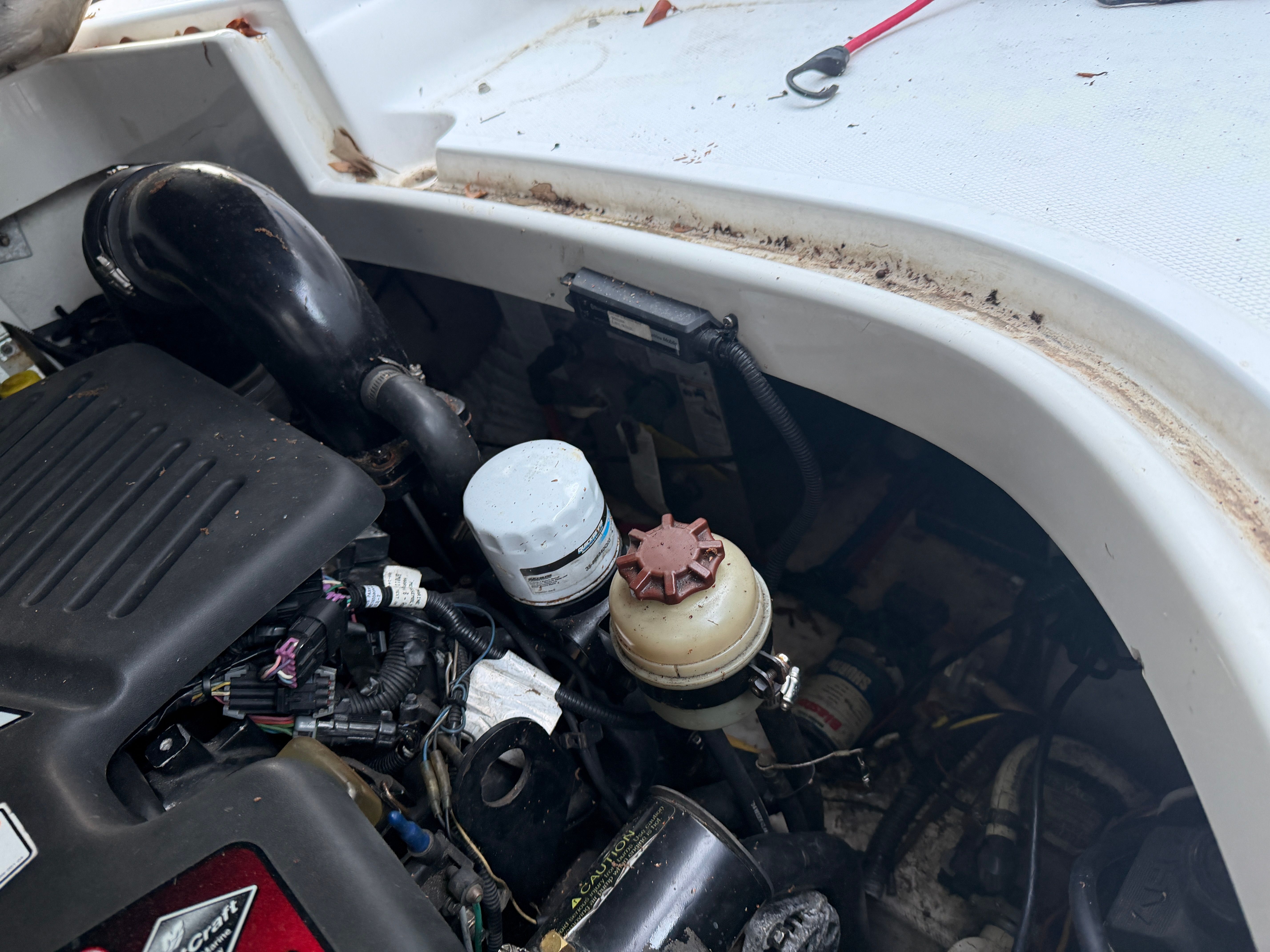 Engine compartment of a 2006 Crownline 270 CR boat, showing engine and components.