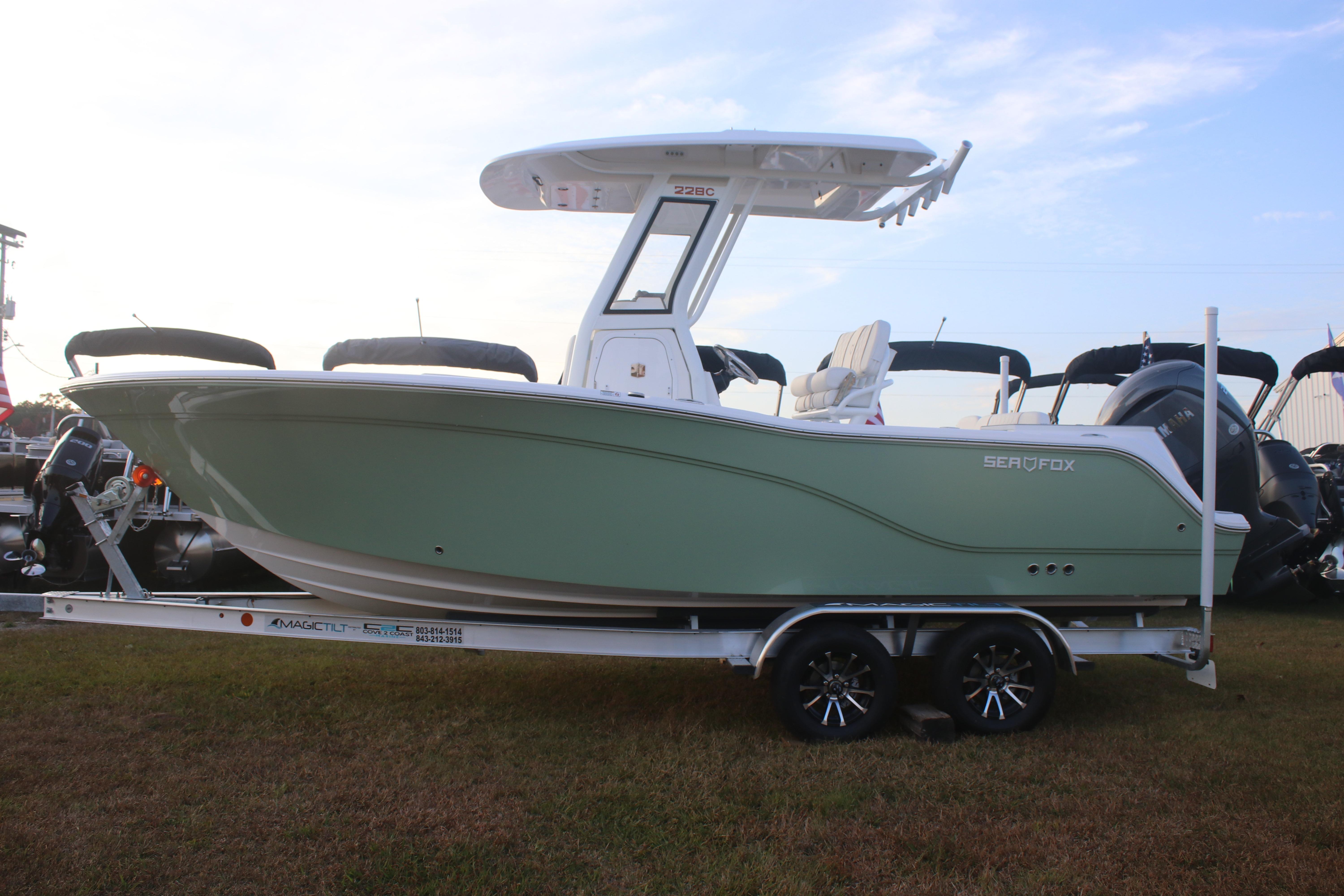 2026 Sea Fox 228 Commander boat on trailer, side view, green hull, outdoor display.