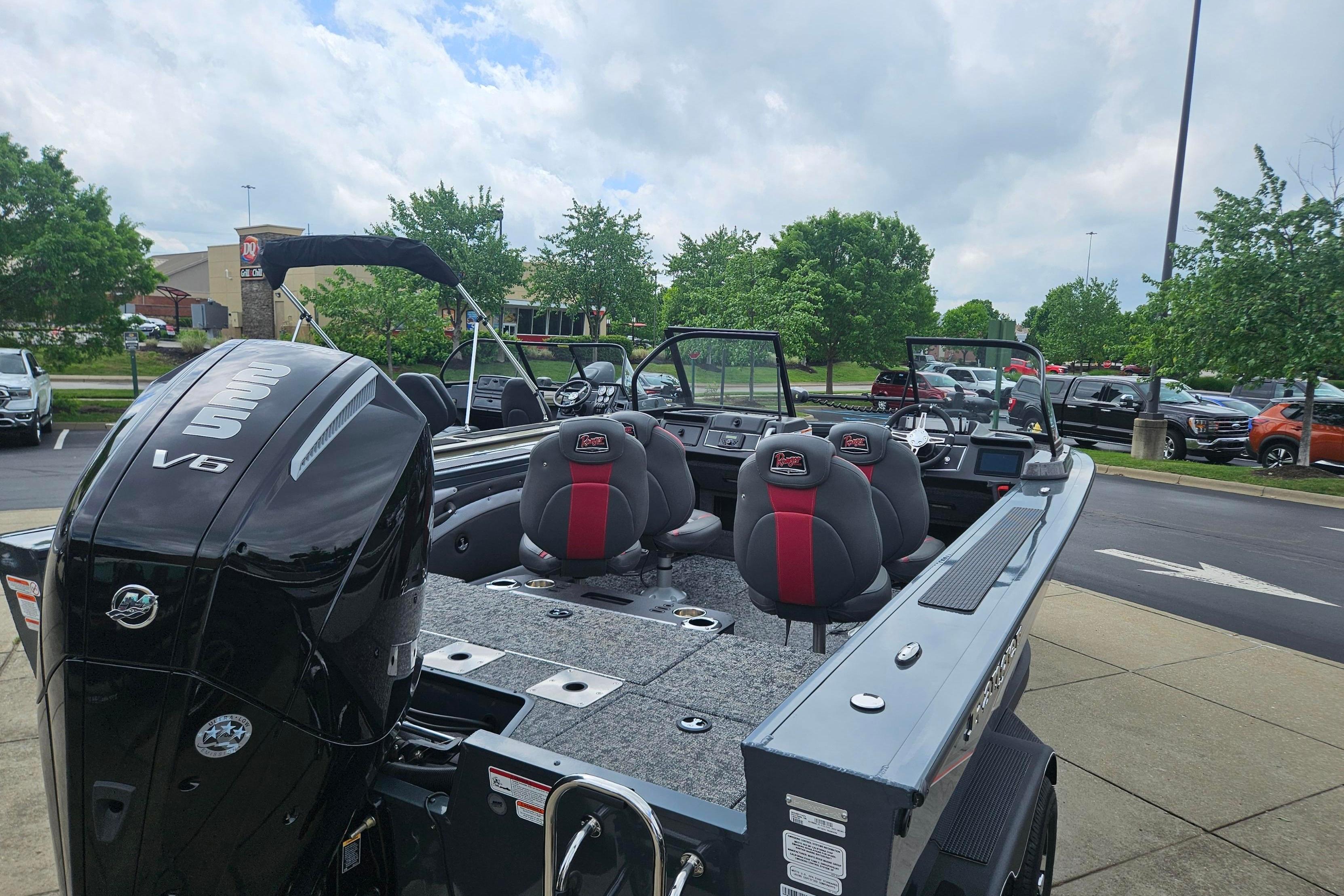 2025 Ranger VX1888 WT boat with V6 engine, parked outdoors on a cloudy day.