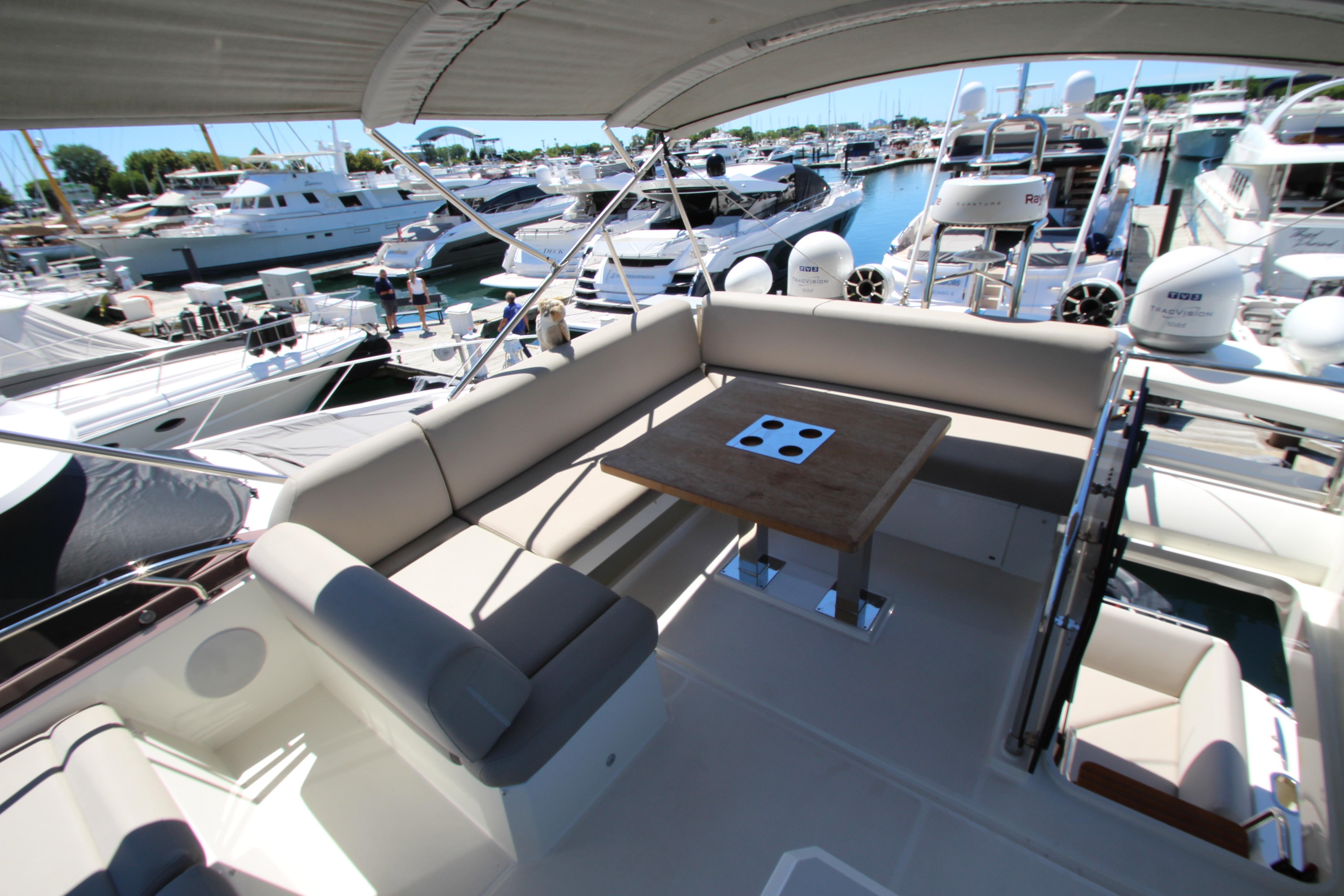Luxurious 2022 Prestige 520 yacht with spacious seating and elegant design at a marina.