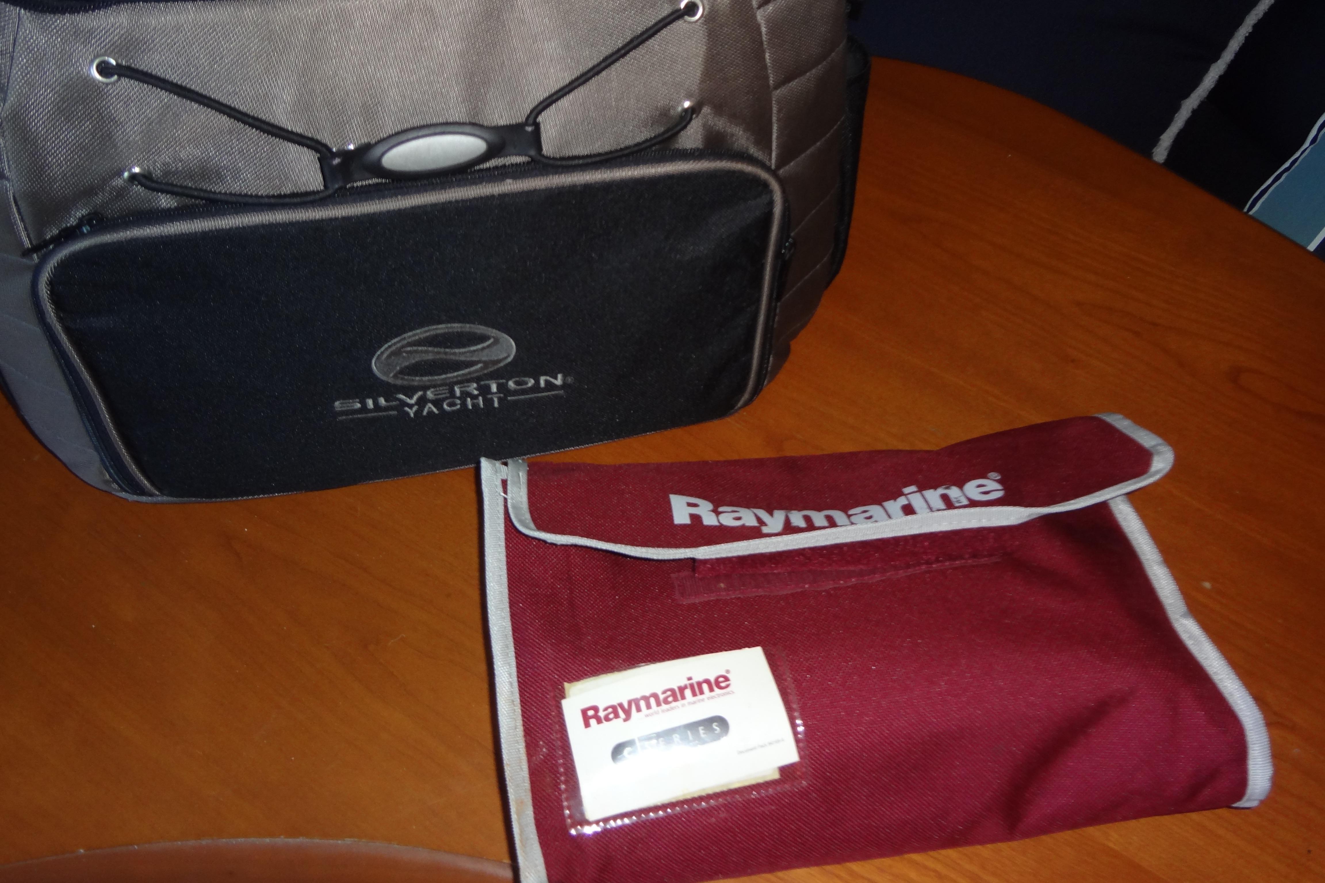 Bag and pouch on table, featuring Silverton Yacht and Raymarine branding.