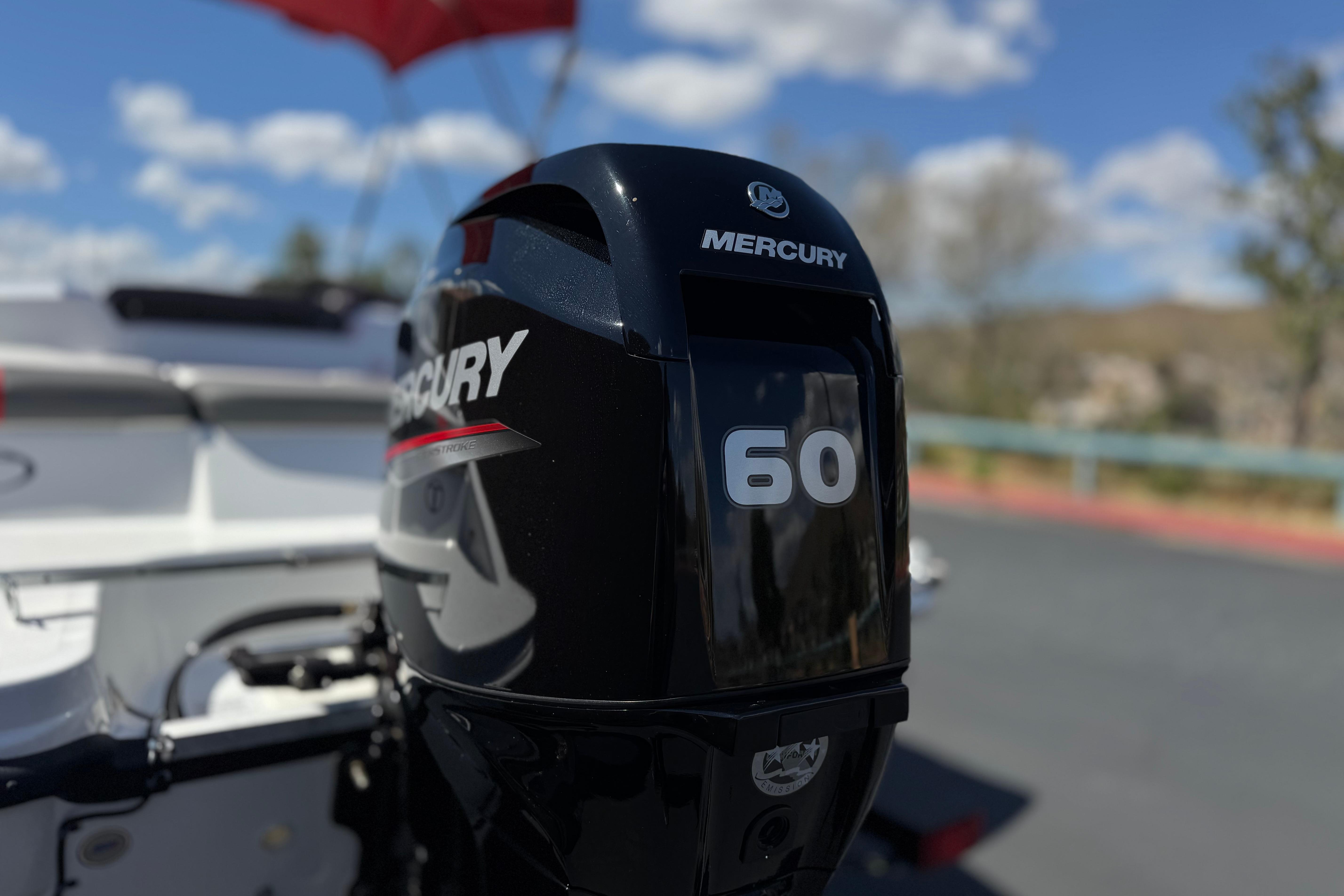 Mercury 60 horsepower engine on 2024 Tahoe T16 boat, outdoors under blue sky.