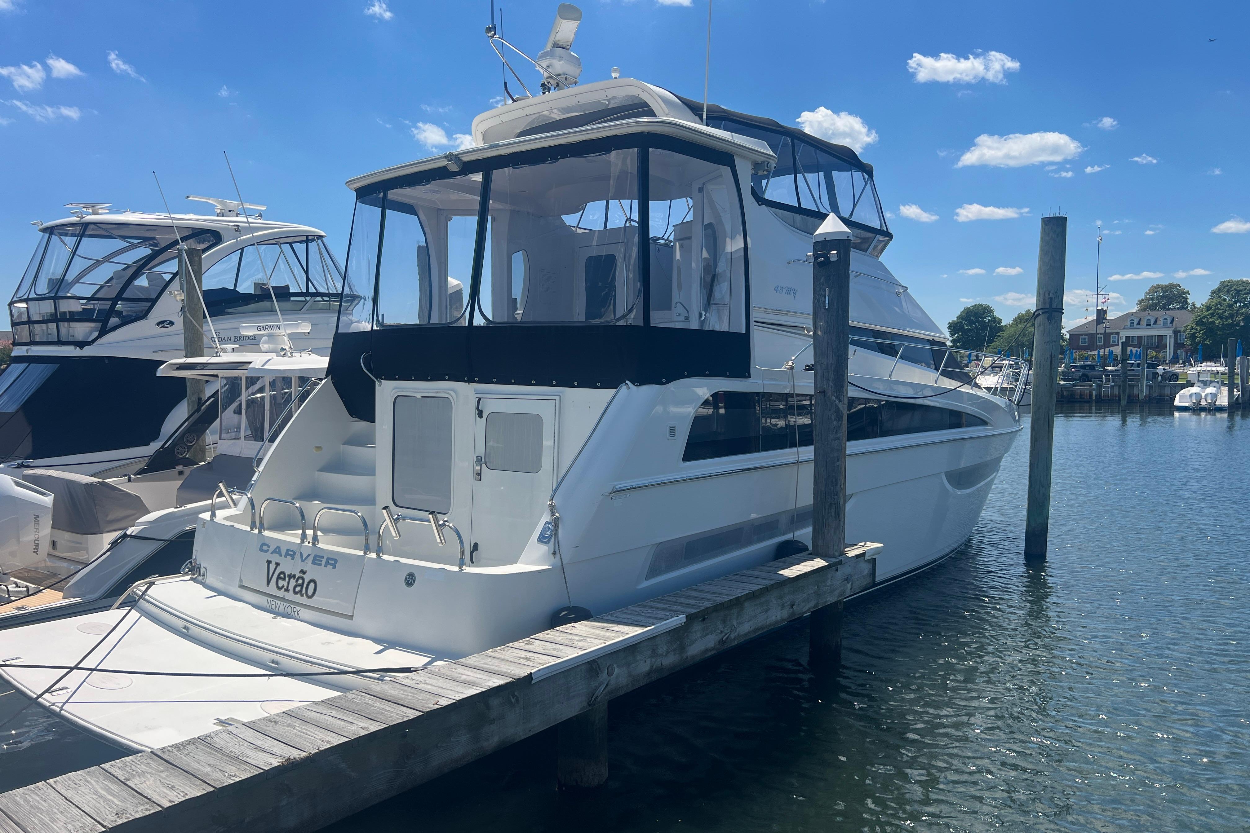 2006 Carver 43 Motor Yacht docked at marina under clear blue sky.