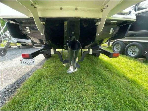 Rear view of a 2022 Chaparral 23 Surf boat on a trailer.