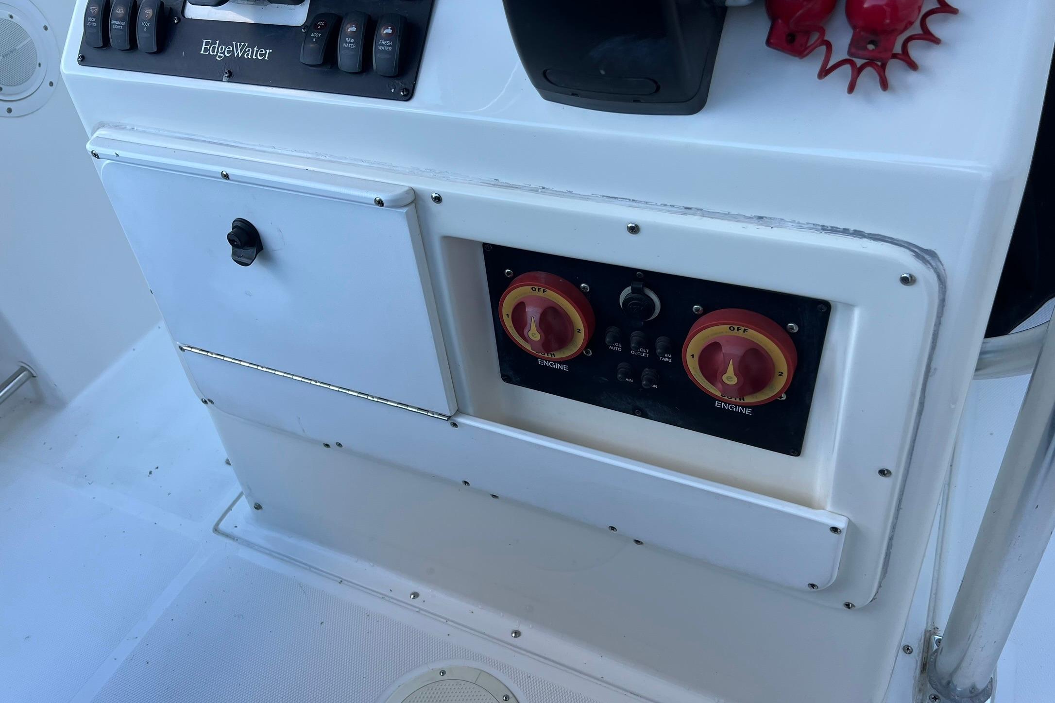 Control panel of a 2006 Edgewater 245CC boat with switches and dials.