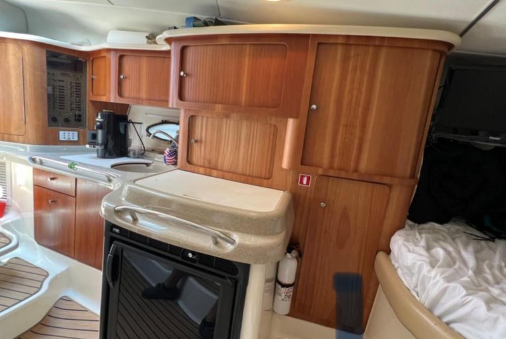 2004 Chris-Craft 33 Express yacht interior with wooden cabinets and modern amenities.