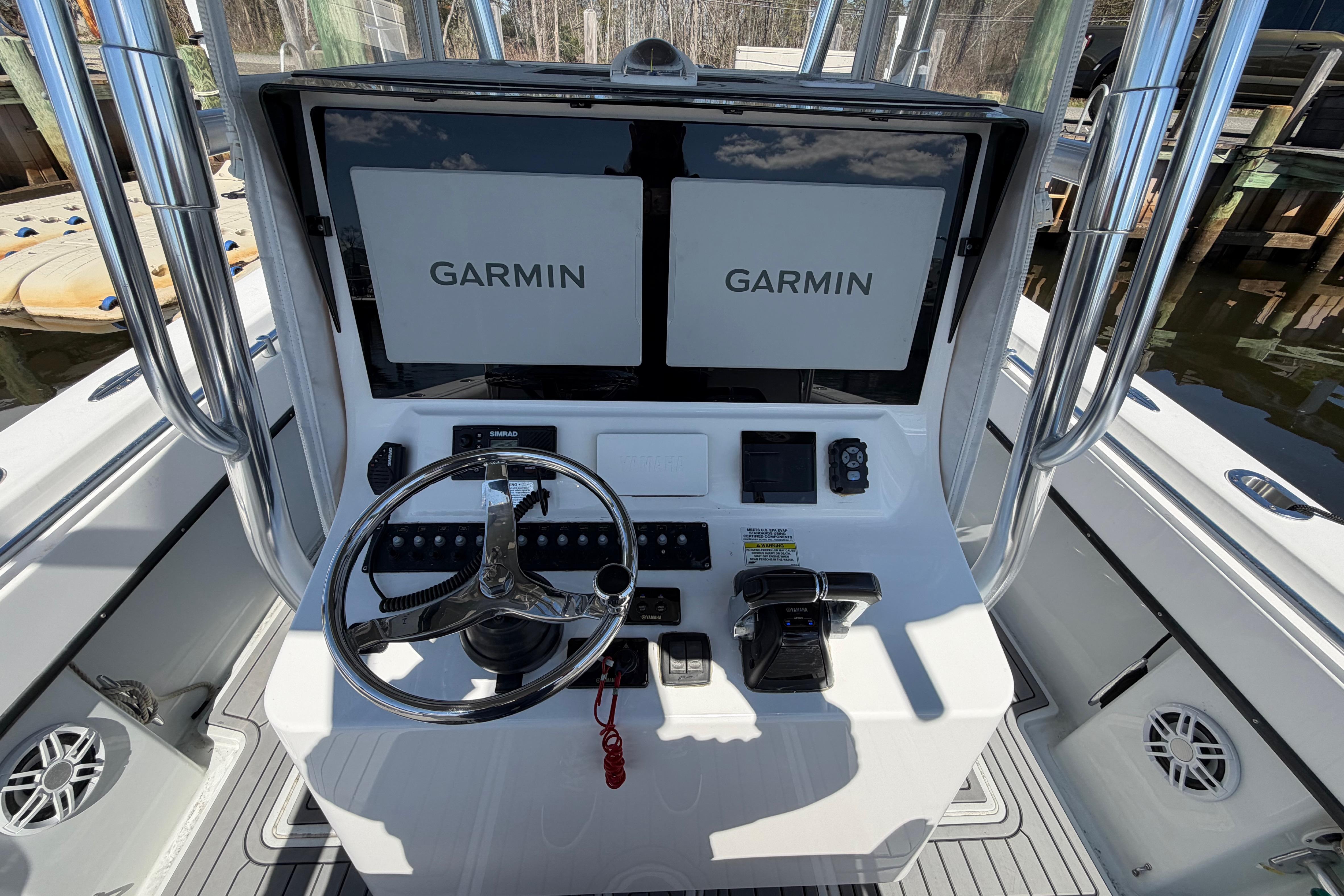Center console of a 2015 Contender 32 ST boat with Garmin displays.