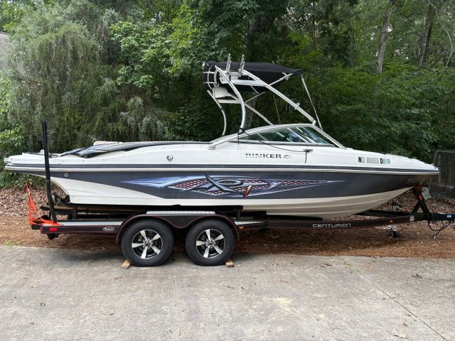A 2007 Rinker 226 Captiva Bowrider on a trailer, surrounded by trees.
