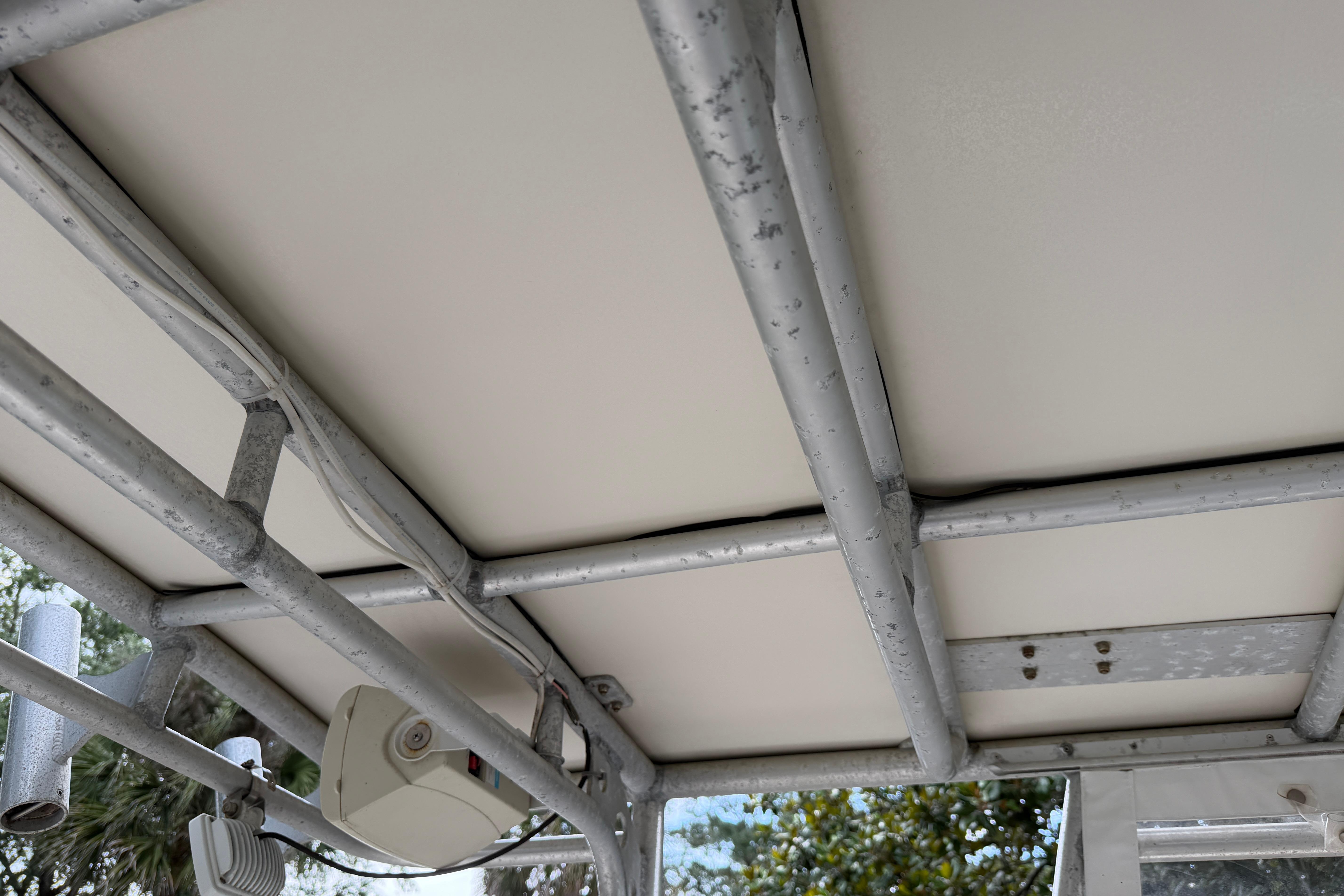 1987 Grady-White Seafarer 226 boat canopy with metal frame and mounted equipment.