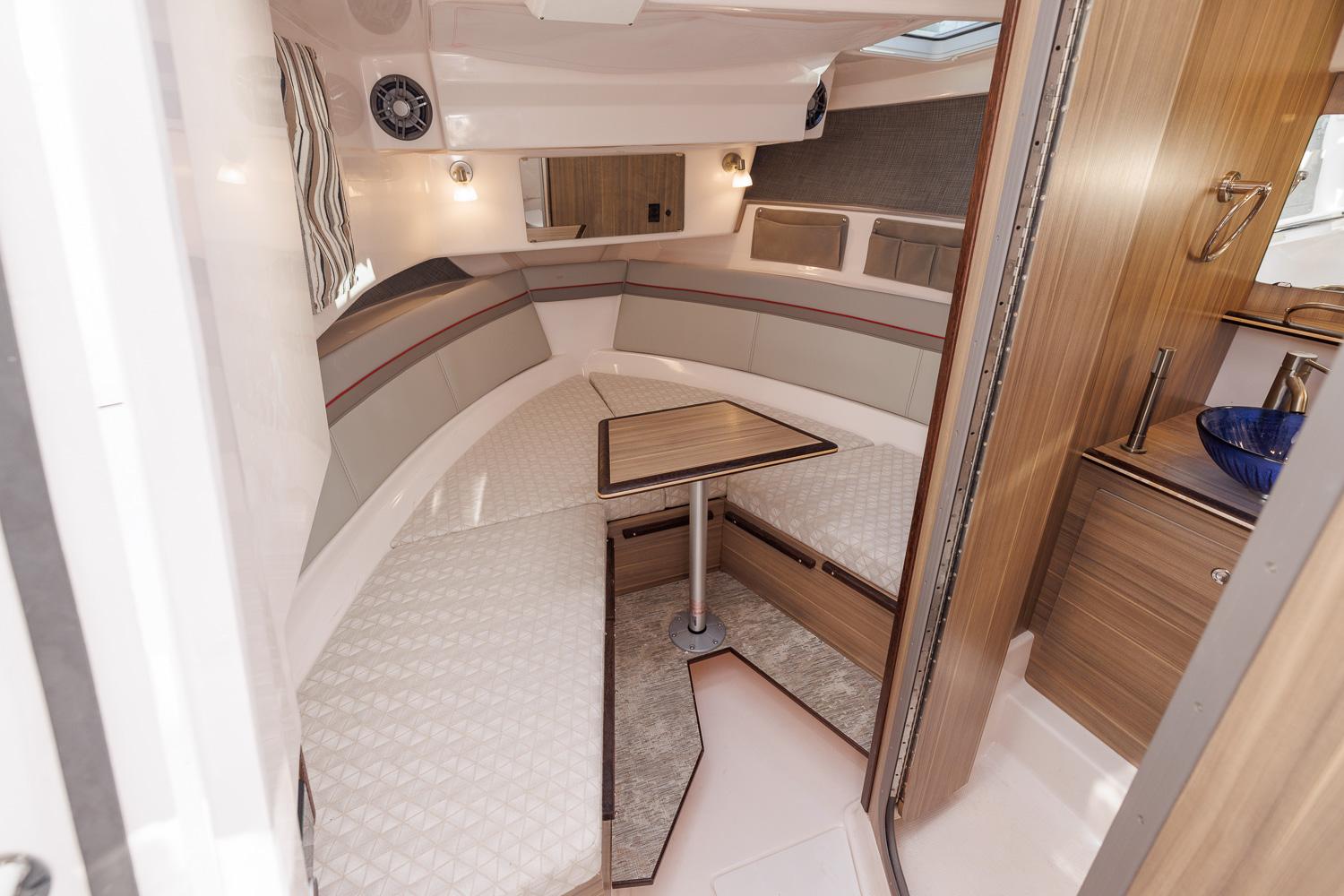 2026 Solara S-310 Sport Bridge interior with cozy seating and wooden table.