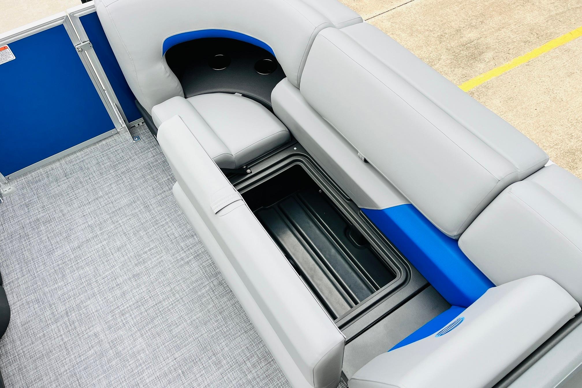 Sun Tracker Party Barge 22 RF DLX interior with open storage compartment, 2026 model.