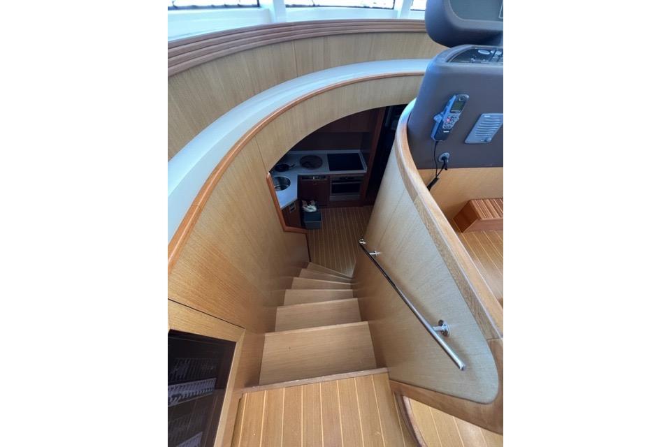 Staircase inside 2008 Apreamare Maestro 65 yacht, featuring elegant wood finish and modern design.