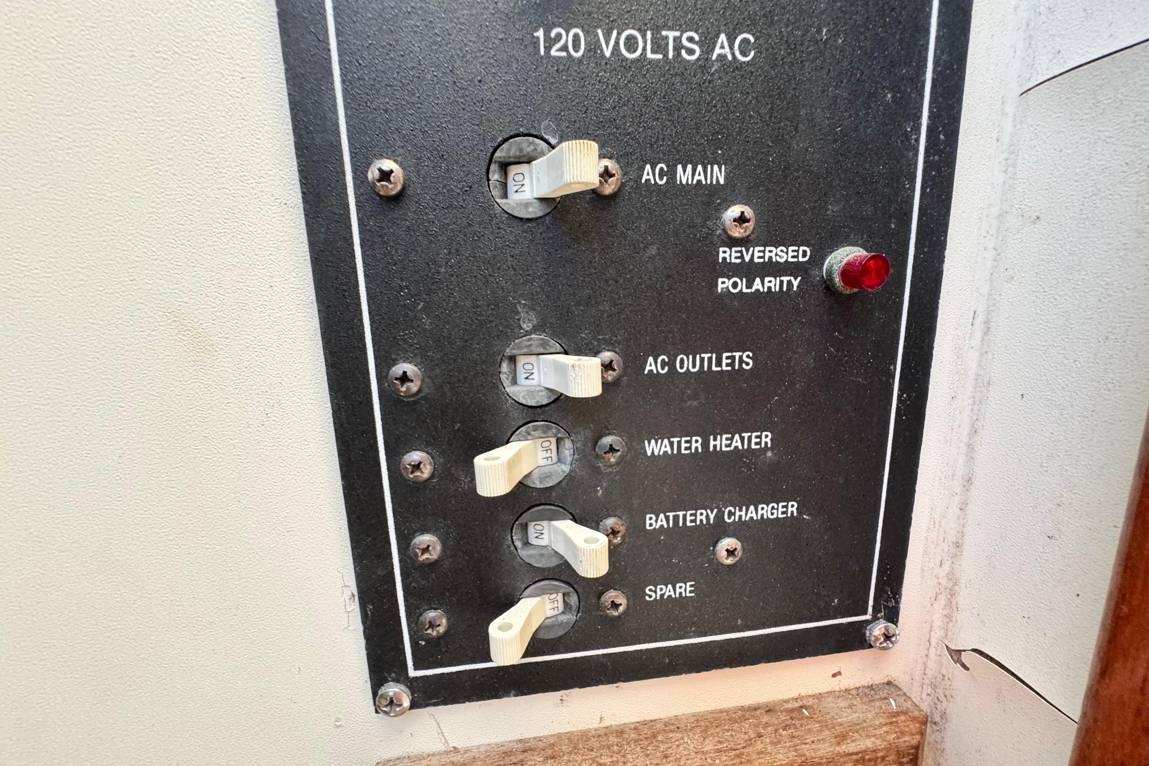 Electrical panel of a 1987 Luhrs Alura 30 boat with switches and reversed polarity indicator.