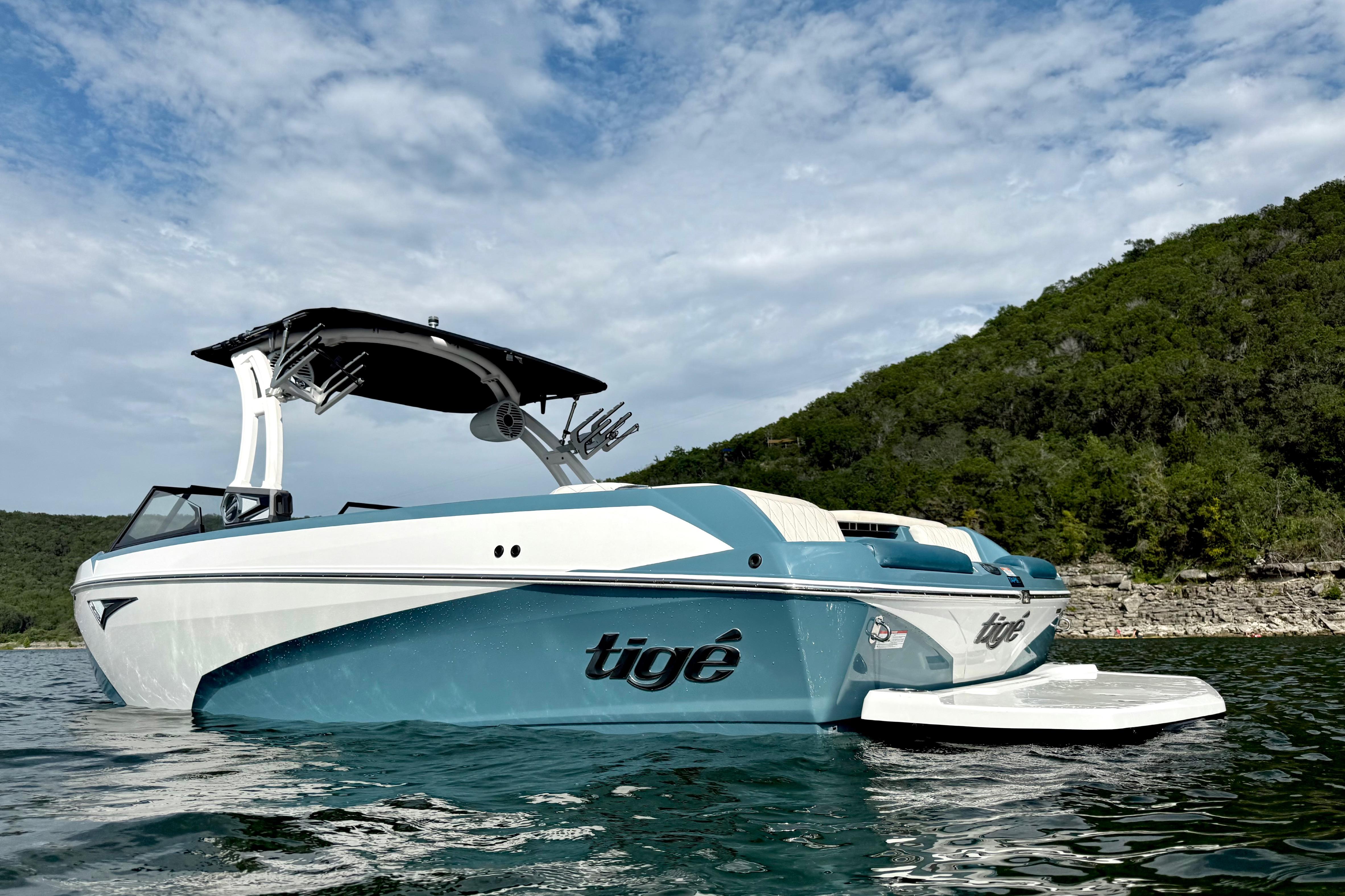 2021 Tige Z3 boat on a lake with scenic forested hills in the background.