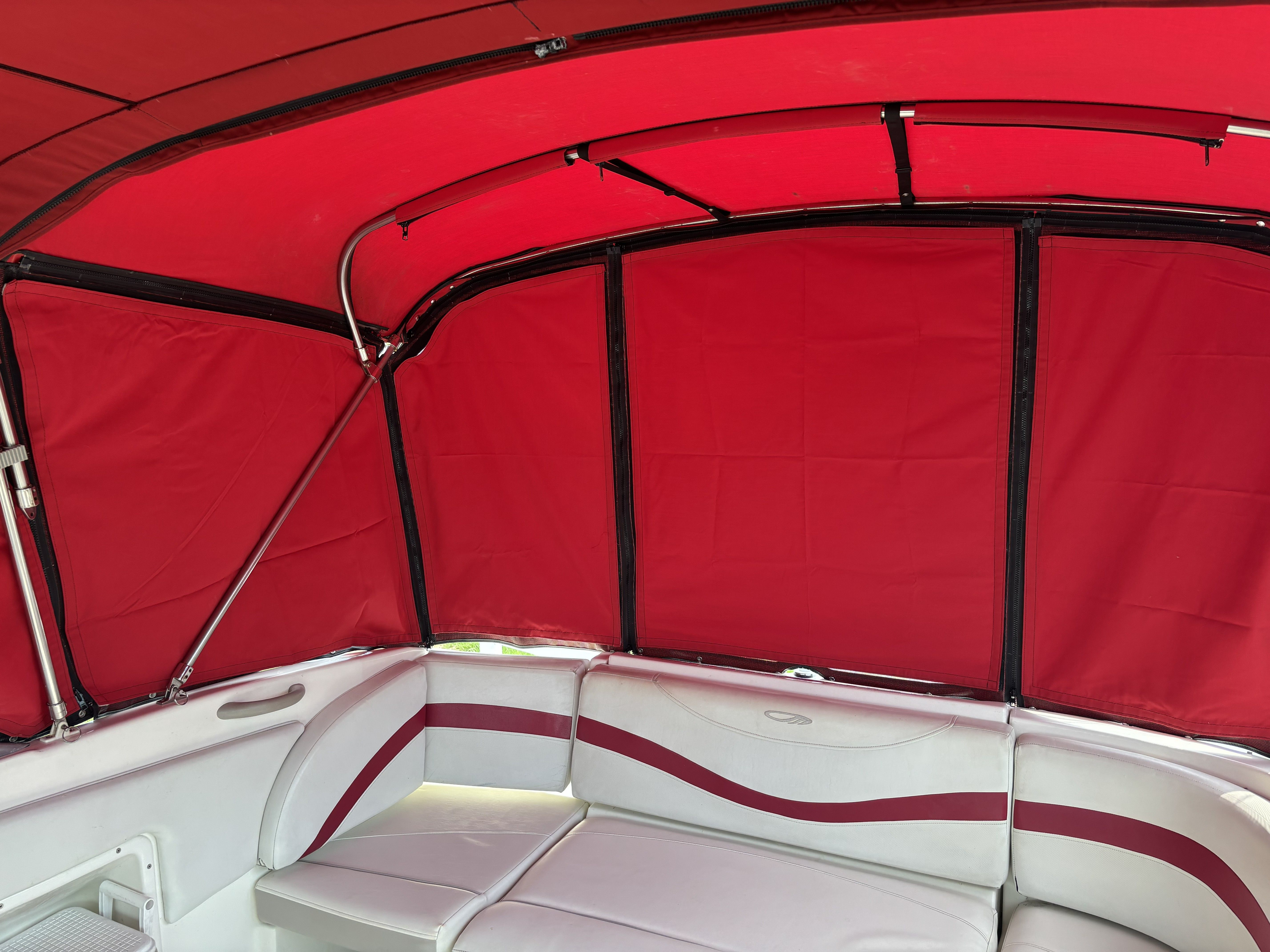 Interior of a 2005 Maxum 2400 SC3 with red canopy.