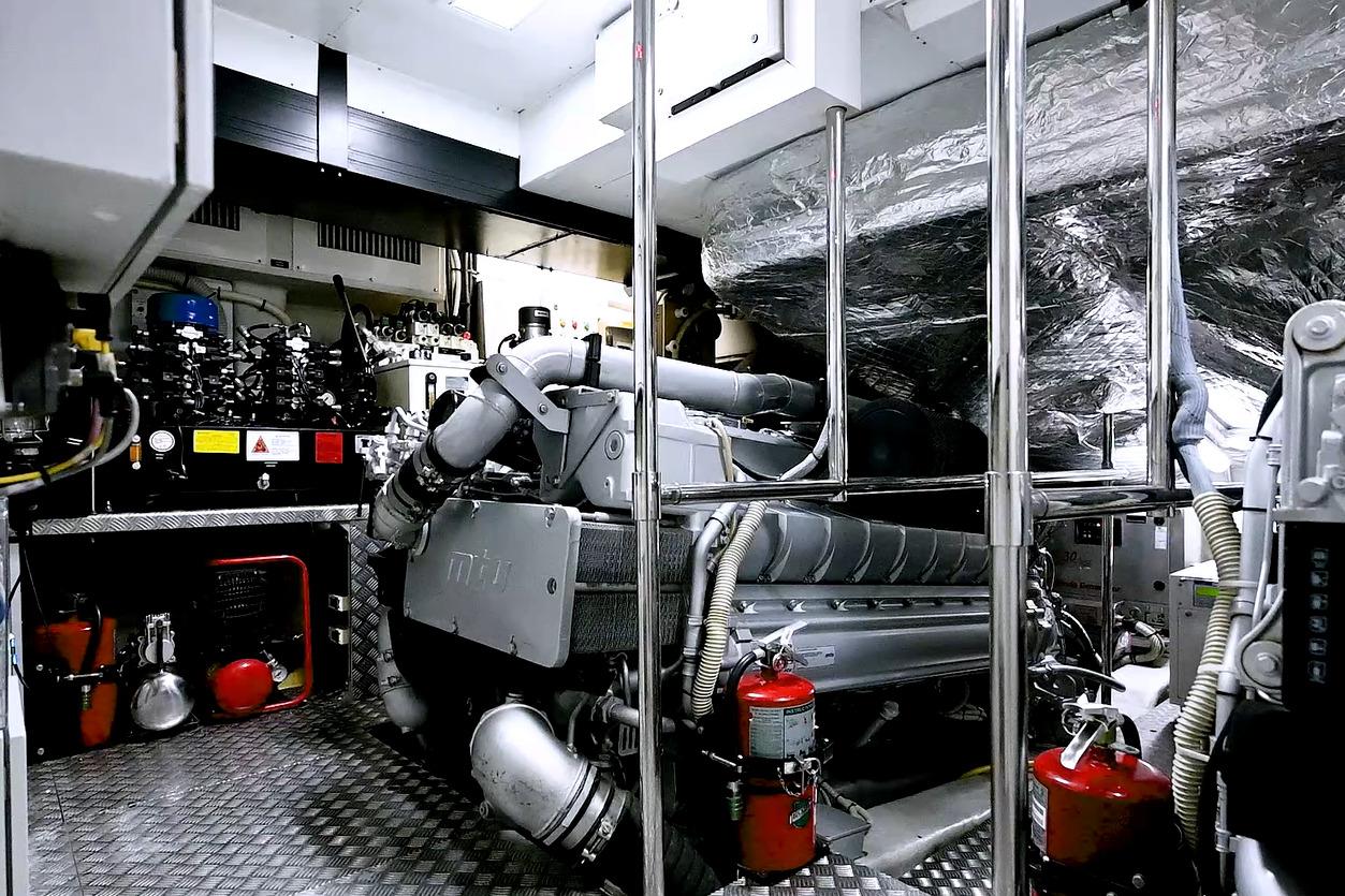 Engine room of a 2015 Pershing 92 yacht, featuring advanced machinery and safety equipment.