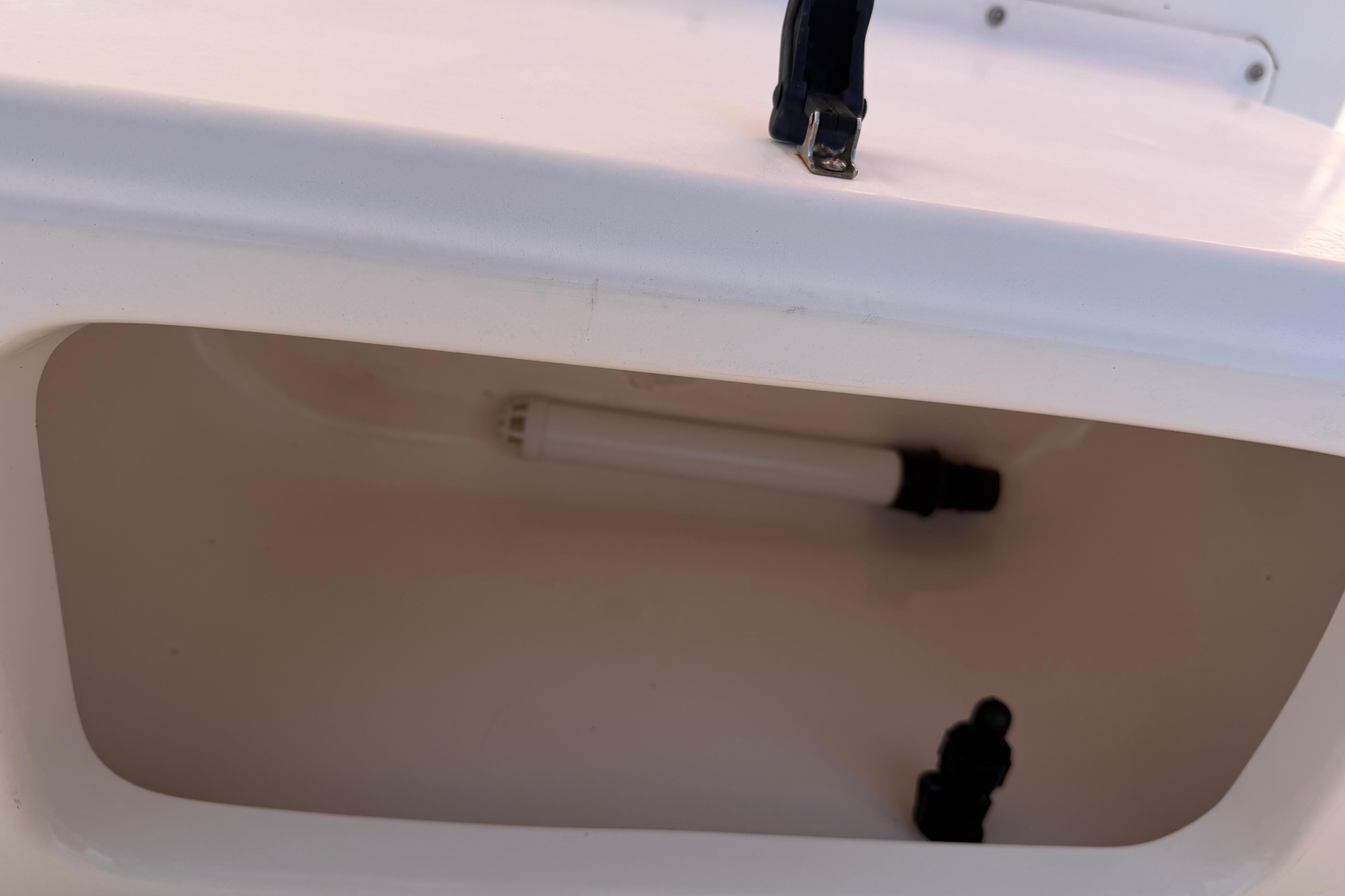 Storage compartment of a 2008 KenCraft Bay Rider 2060 boat with interior light.