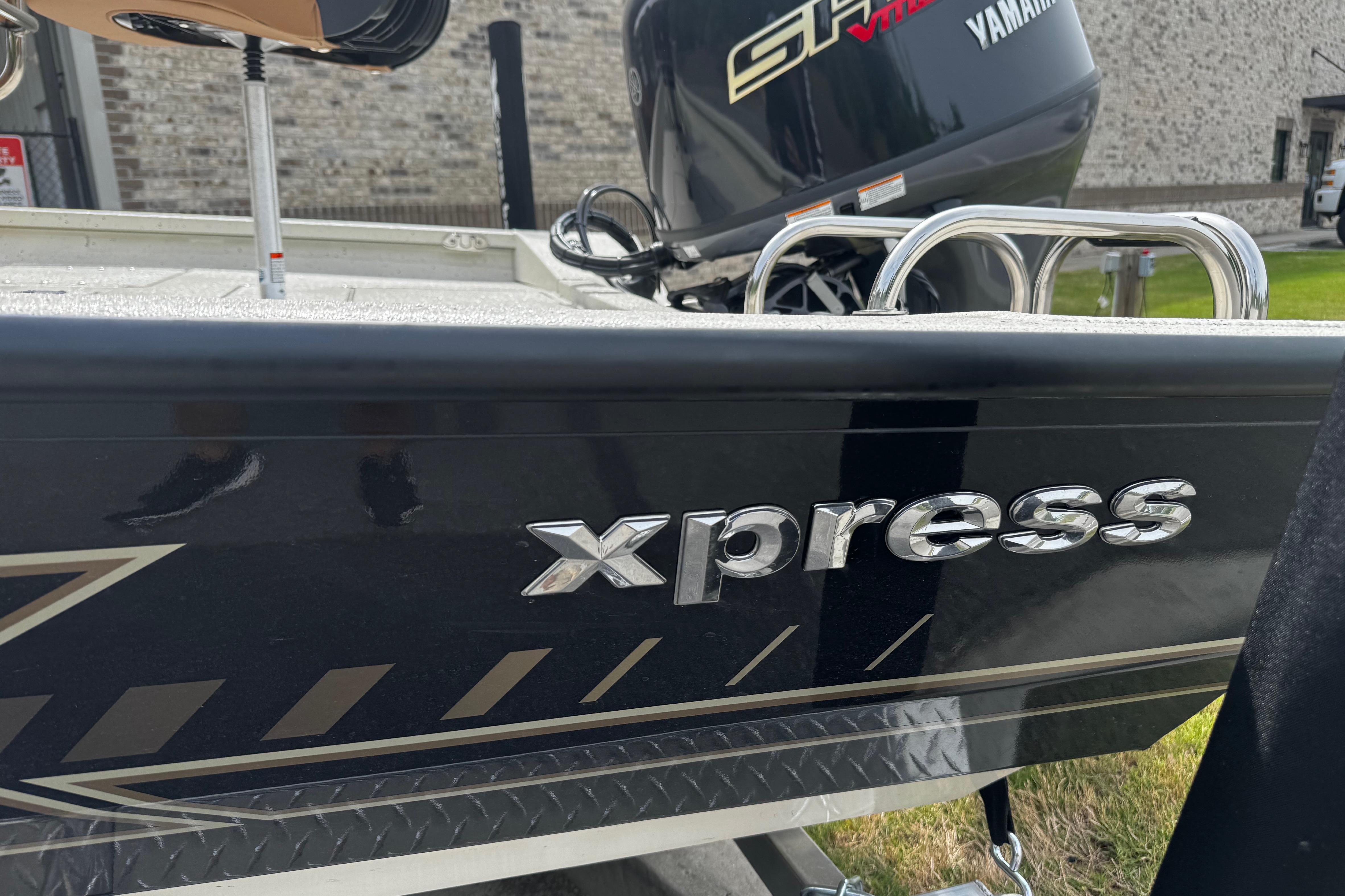 2026 Xpress H20B Bay boat with Yamaha engine, side view.