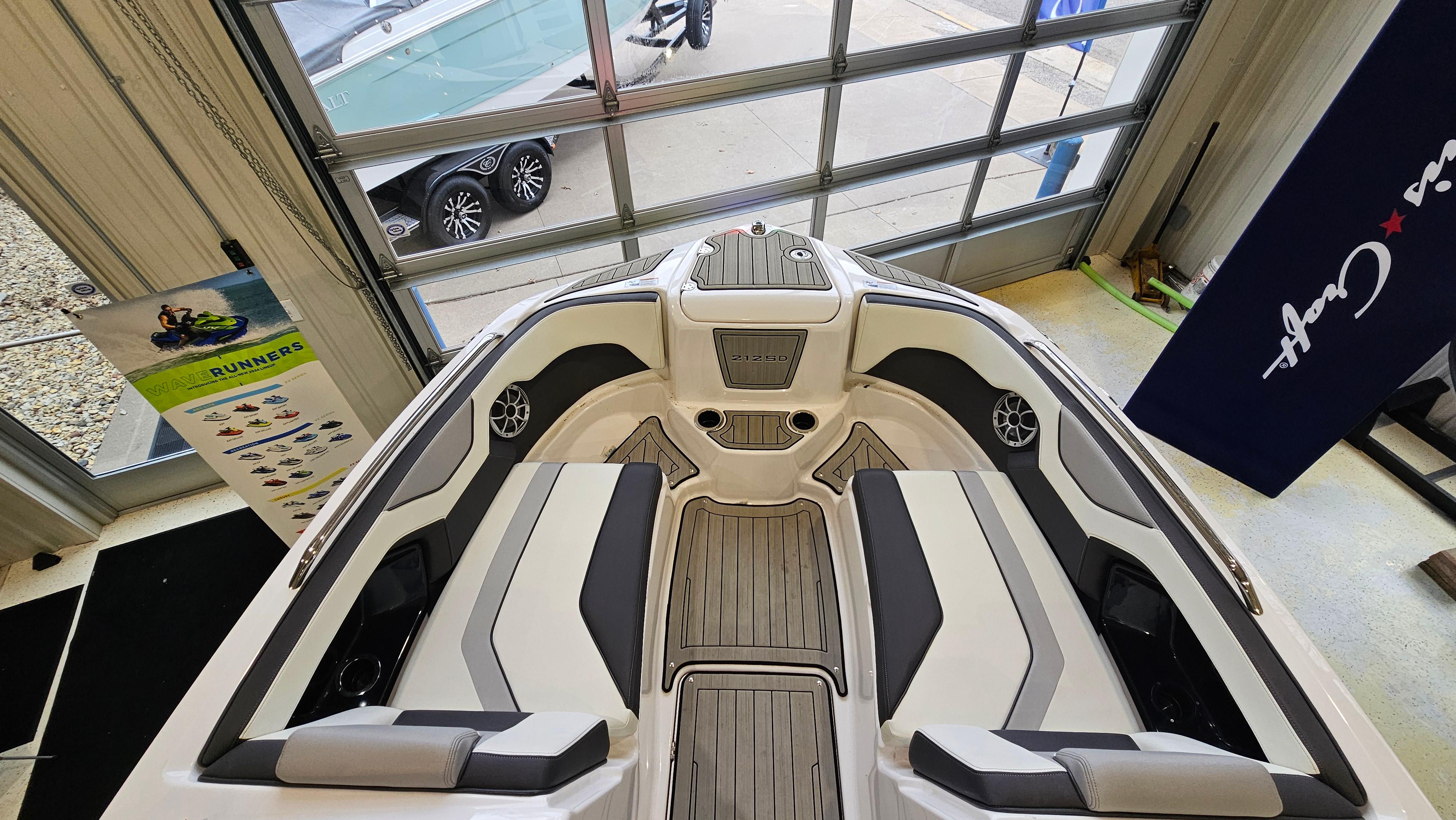 Interior view of 2021 Yamaha Boats 212SD, showcasing seating and deck design.