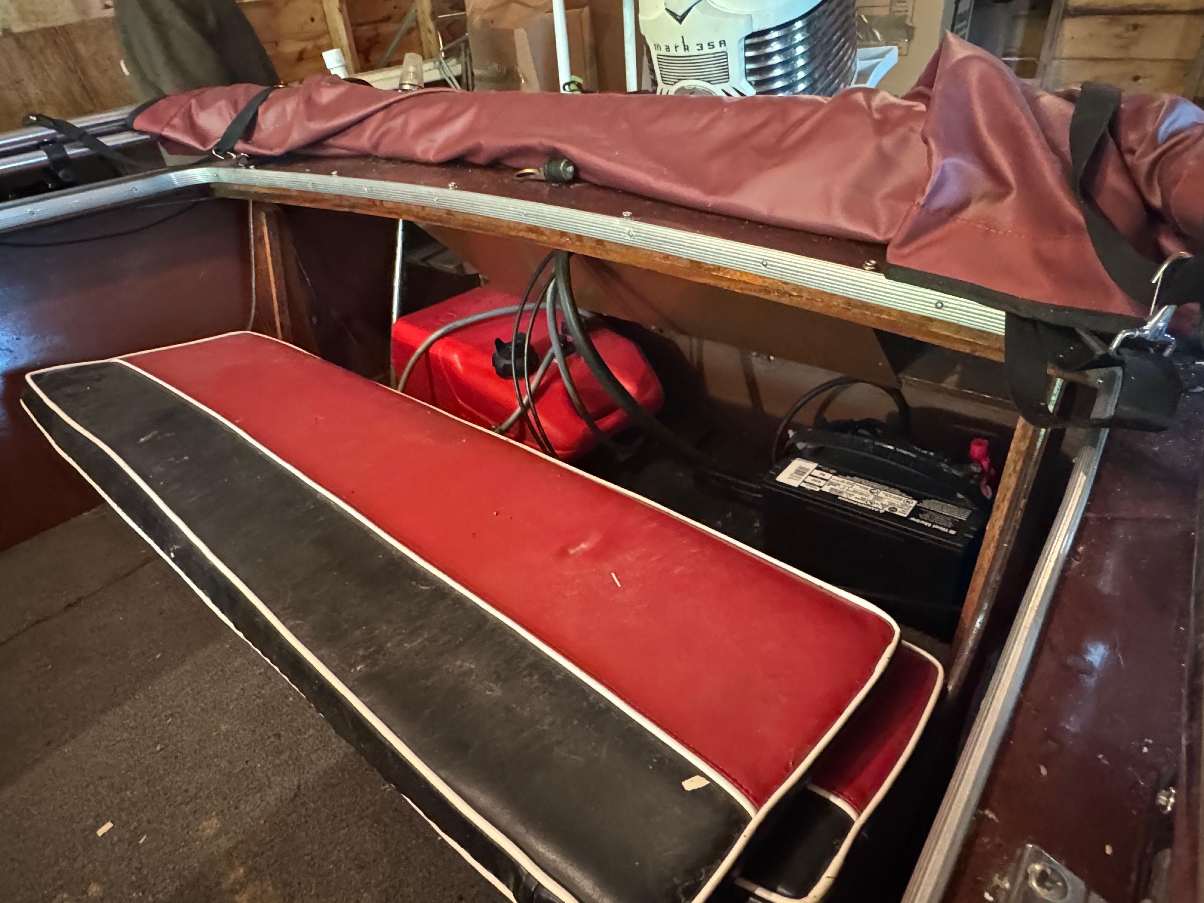Interior of a 1958 Classic Sportcraft Runabout with red seating.