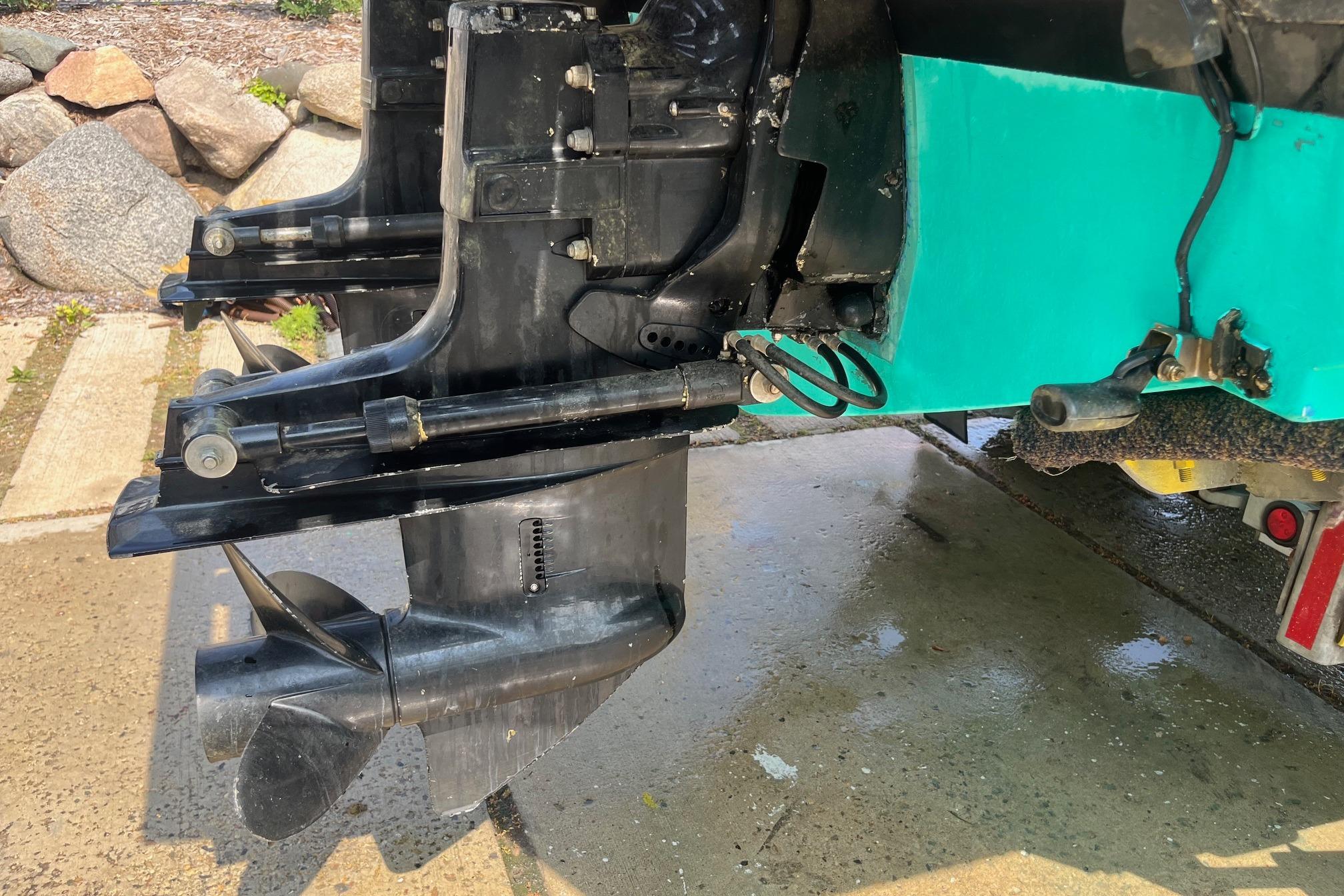 Close-up of a 1975 Bertram 26 Moppie boat's outboard motor and propeller.