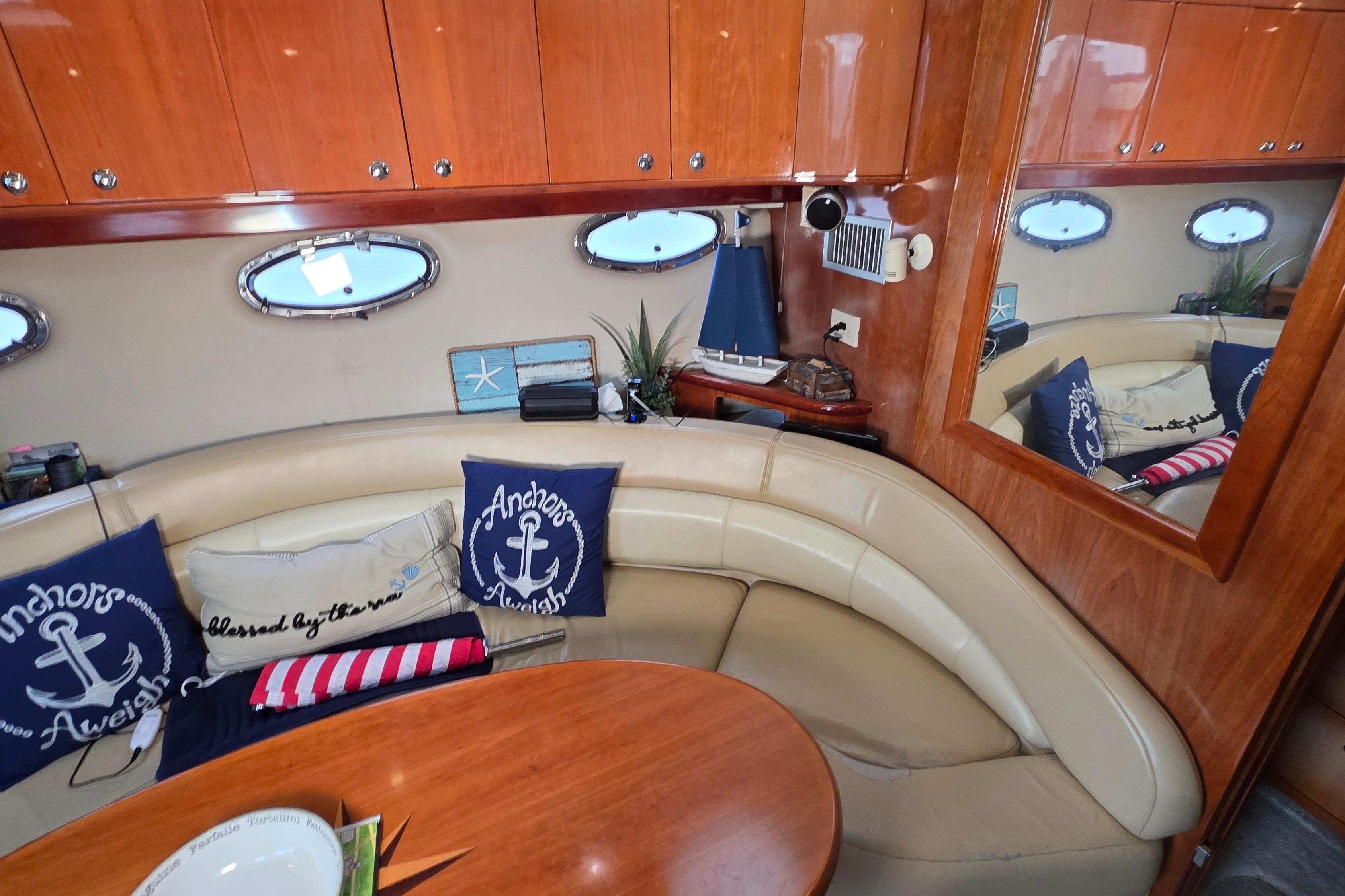 Luxurious 2002 Regal Commodore 4260 yacht interior with nautical decor and plush seating.
