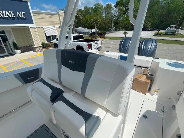 2023 Robalo R270 boat interior with seating and console at a marine dealership.