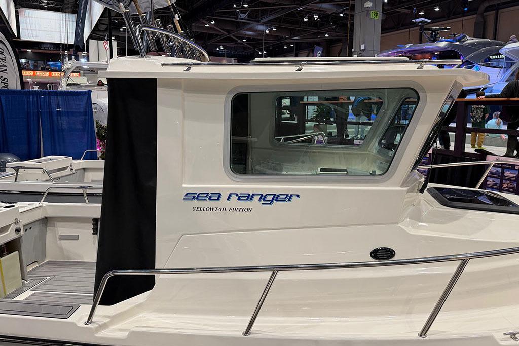 Manufacturer Provided Image: 2026 Arima Sea Ranger 21 Yellowtail Edition boat showcased at an indoor exhibition.