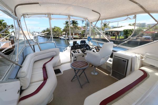 1992 Sea Ray 350 Express Bridge interior with helm, seating, and waterway view.