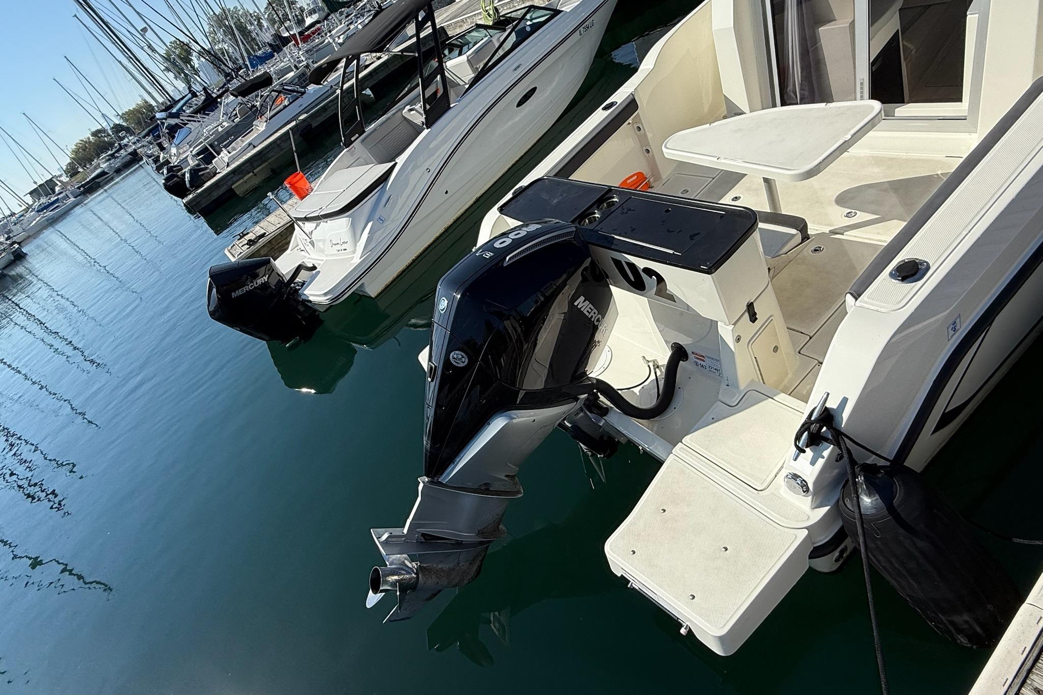 2024 Bayliner Trophy T25 Pilothouse docked with Mercury outboard engine.