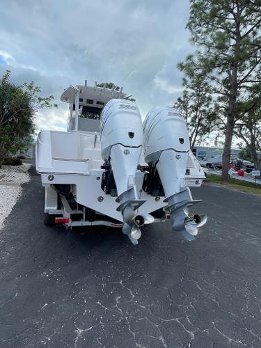 2014 Everglades 325 Center Console boat with dual outboard engines on a paved road.