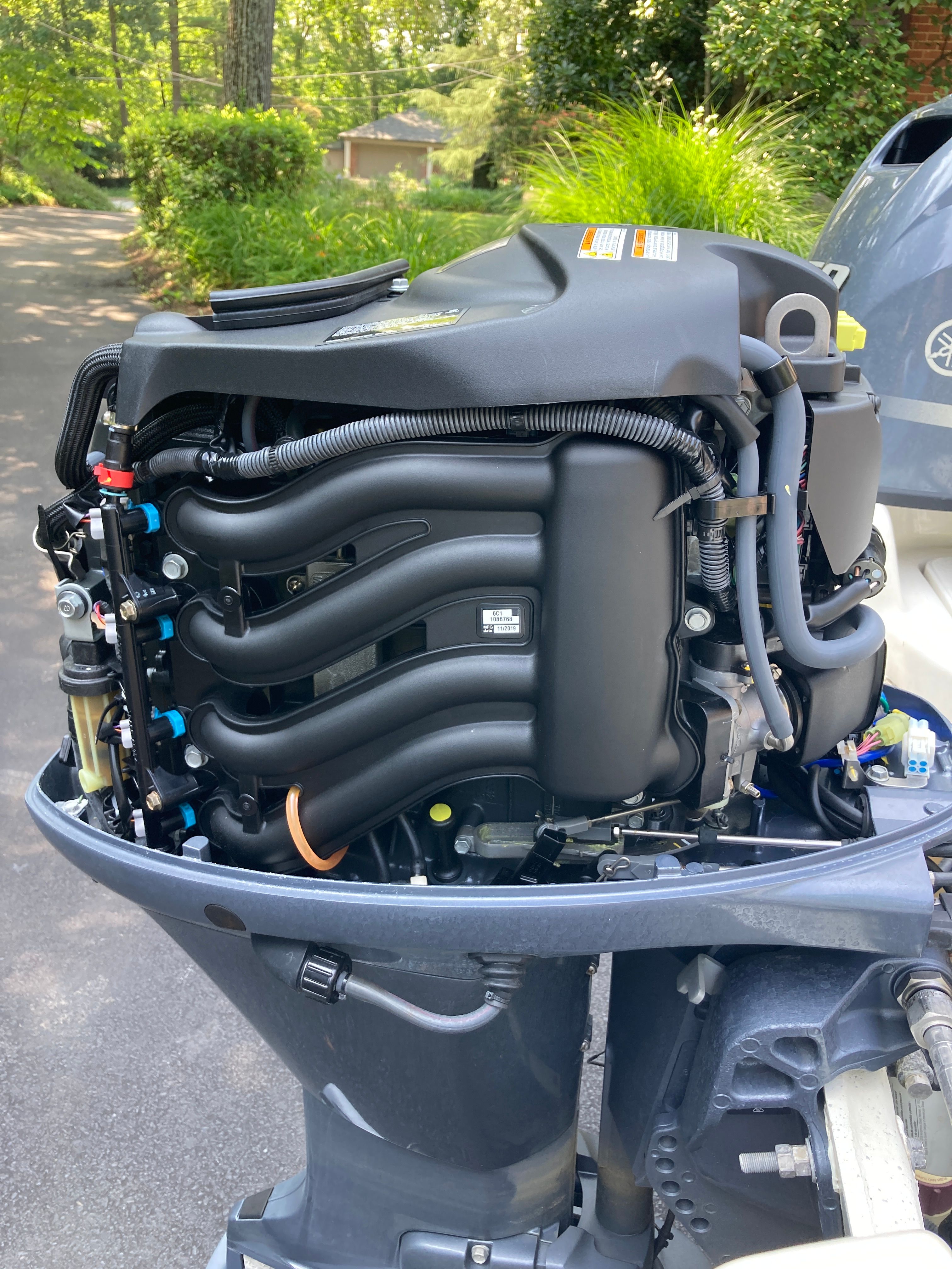 An outboard motor with its casing open, revealing internal components.