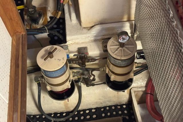 Engine room of 1986 Kadey-Krogen 42 with fuel filters and gauges.