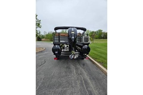 2026 Ranger 220FC boat on a paved road, rear view with outboard motor.