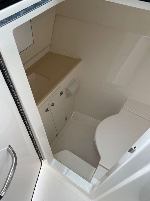 Interior view of a boat with a white sink and storage area.