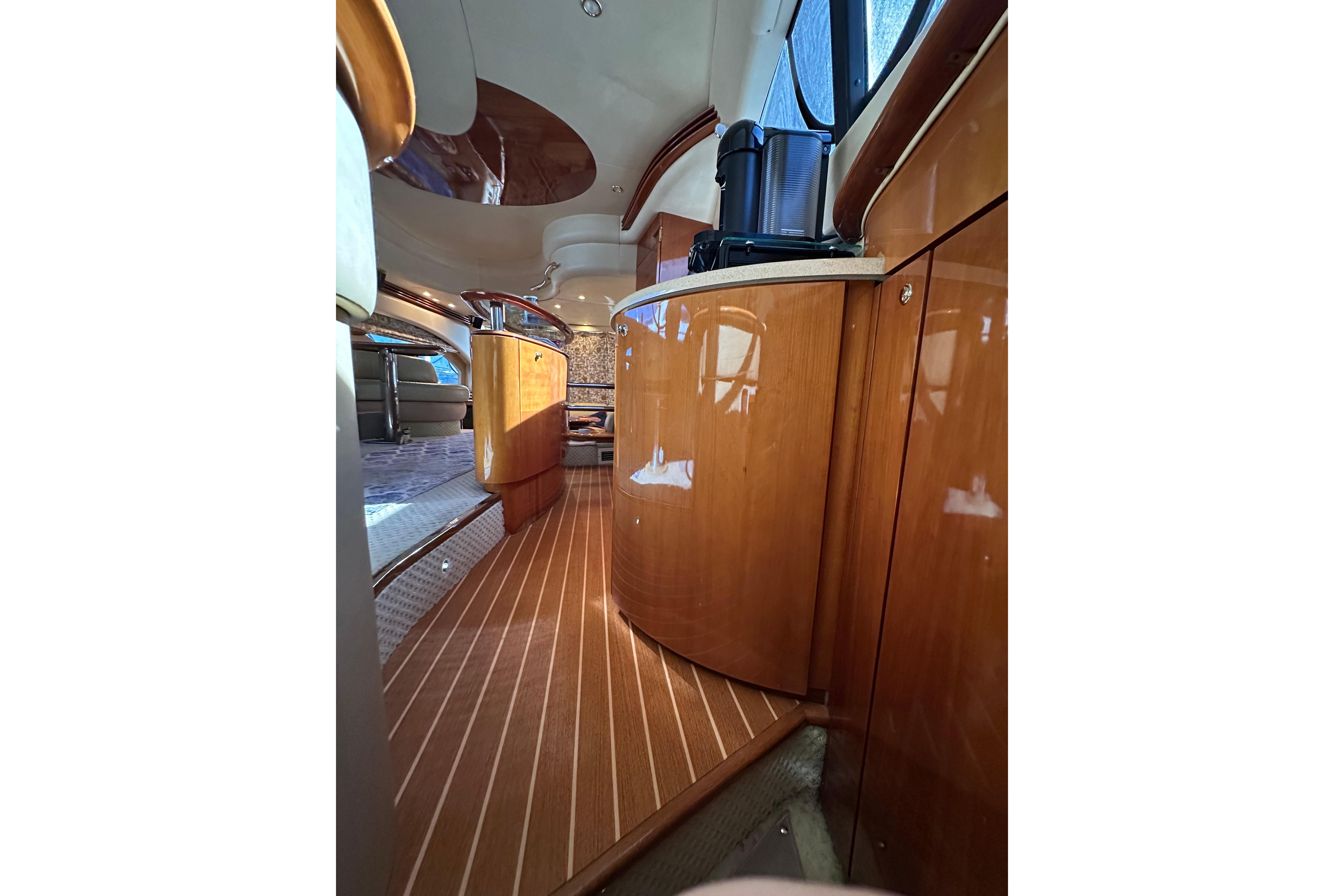 Luxurious interior of a 2004 Azimut 55E yacht with polished wood finishes.