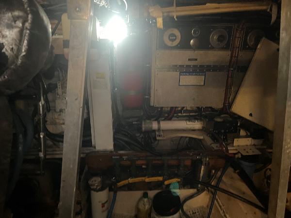 Engine room of 1985 Hatteras 45 Convertible boat with mechanical equipment and wiring.