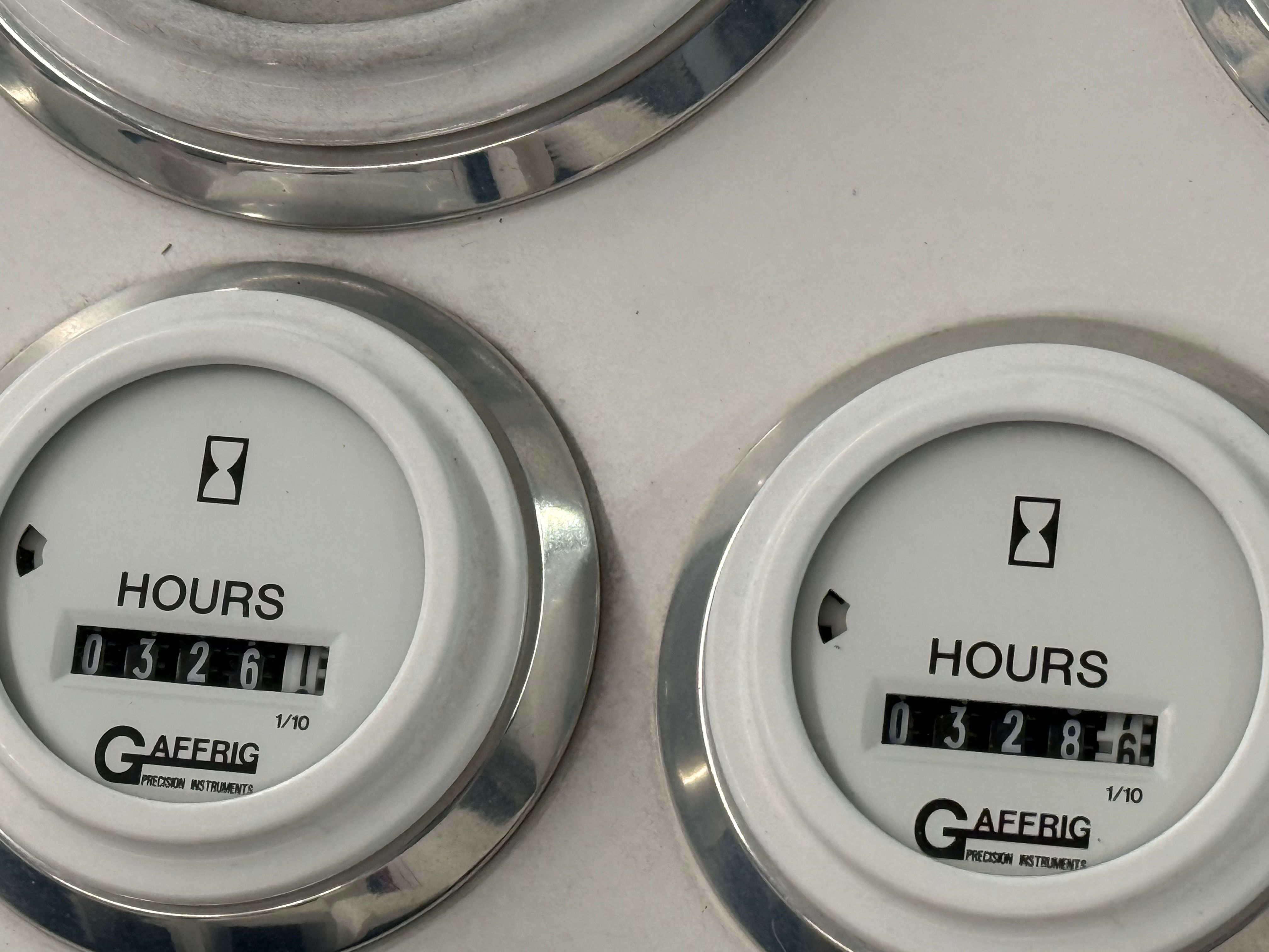 Hour meters on a boat panel, displaying operating hours.