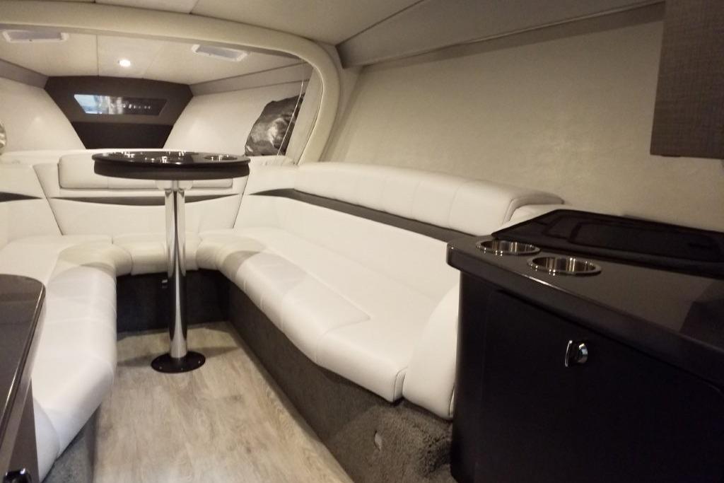 Luxurious interior of 2019 Formula 382 FASTech boat with white seating and table.