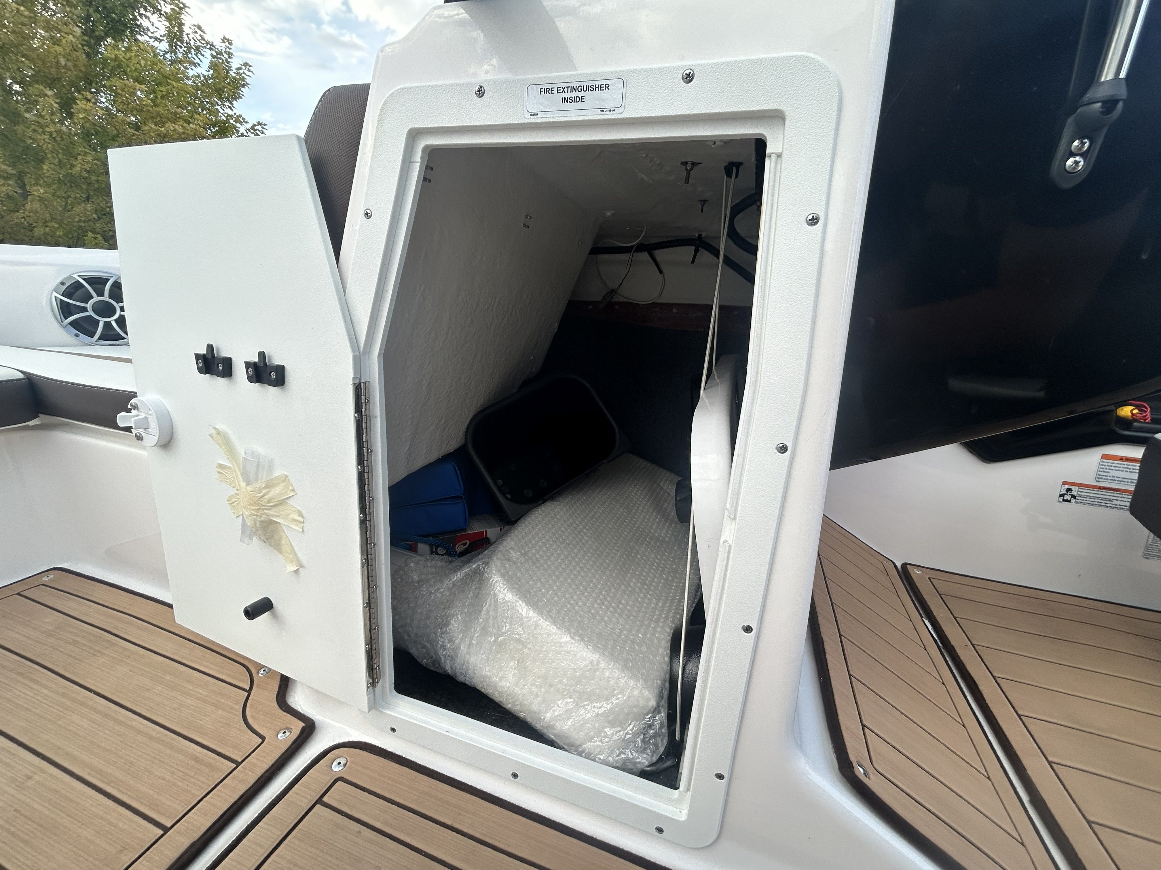 Yamaha Boats 195S 2022 storage compartment with open door.