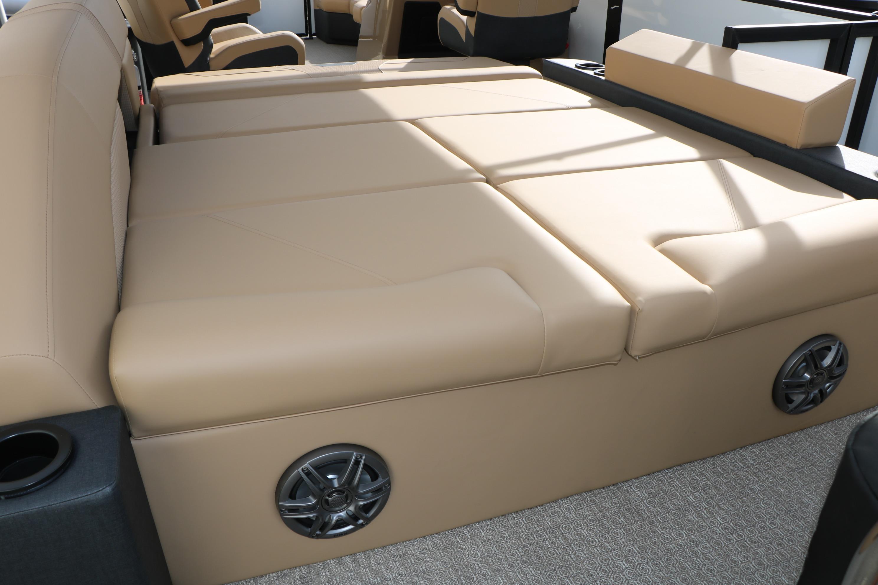 Luxurious beige seating in 2026 Evotti 523CS boat, featuring integrated speakers and cup holders.