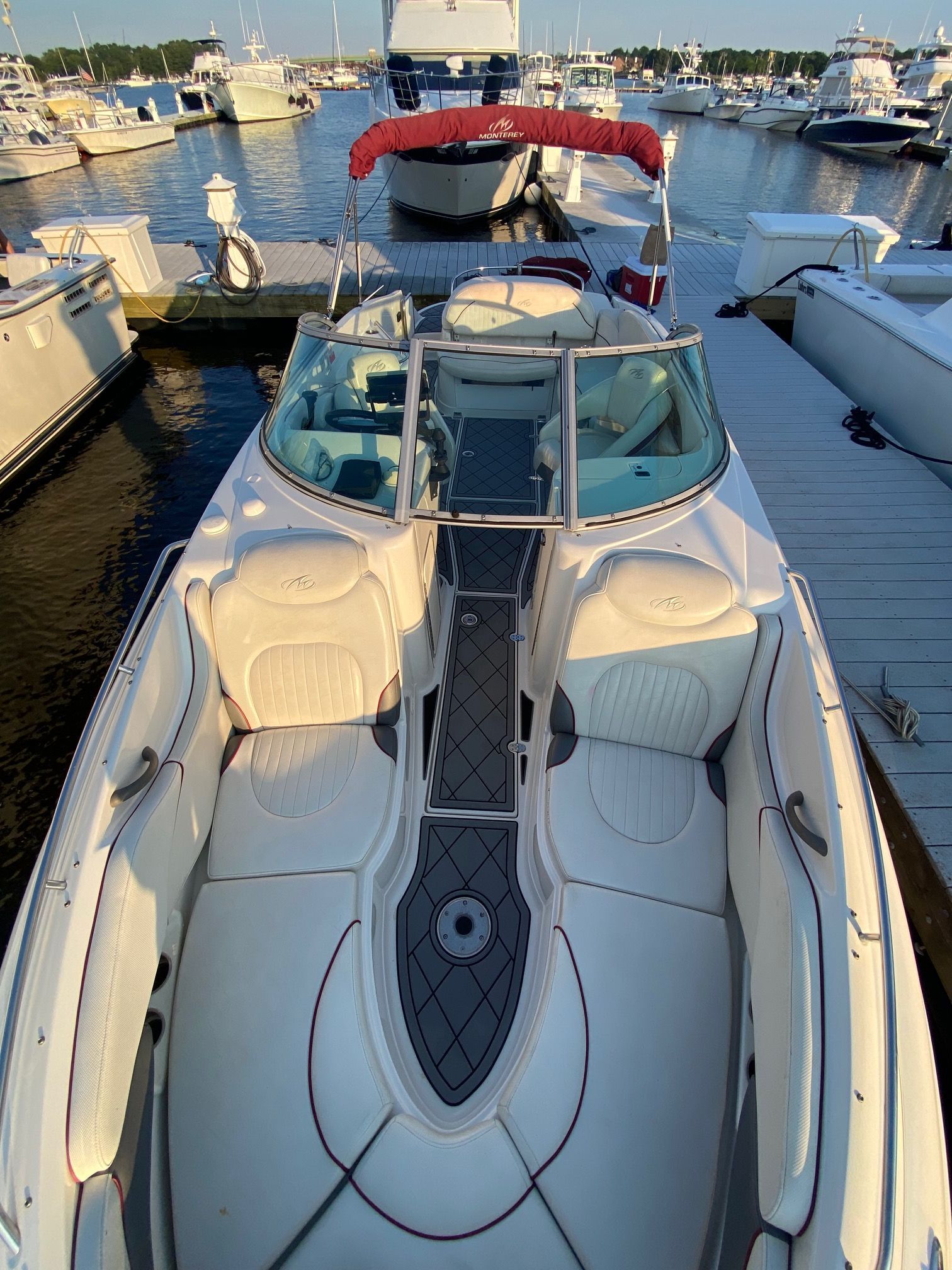A 2006 Monterey 268SS Super Sport docked. It features a spacious, sleek deck.